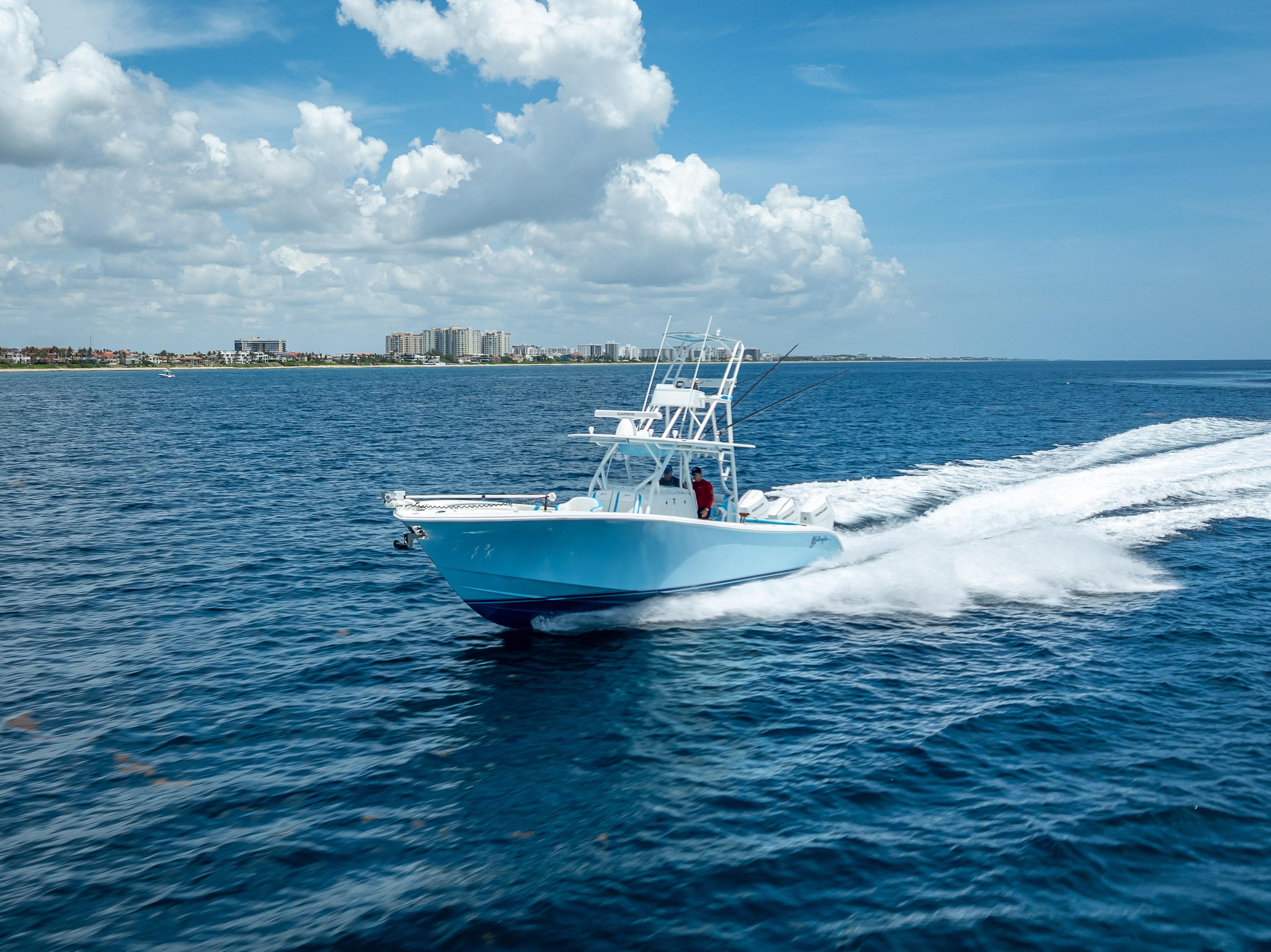2016 Yellowfin 39 Offshore boat cruising on open ocean under blue sky.