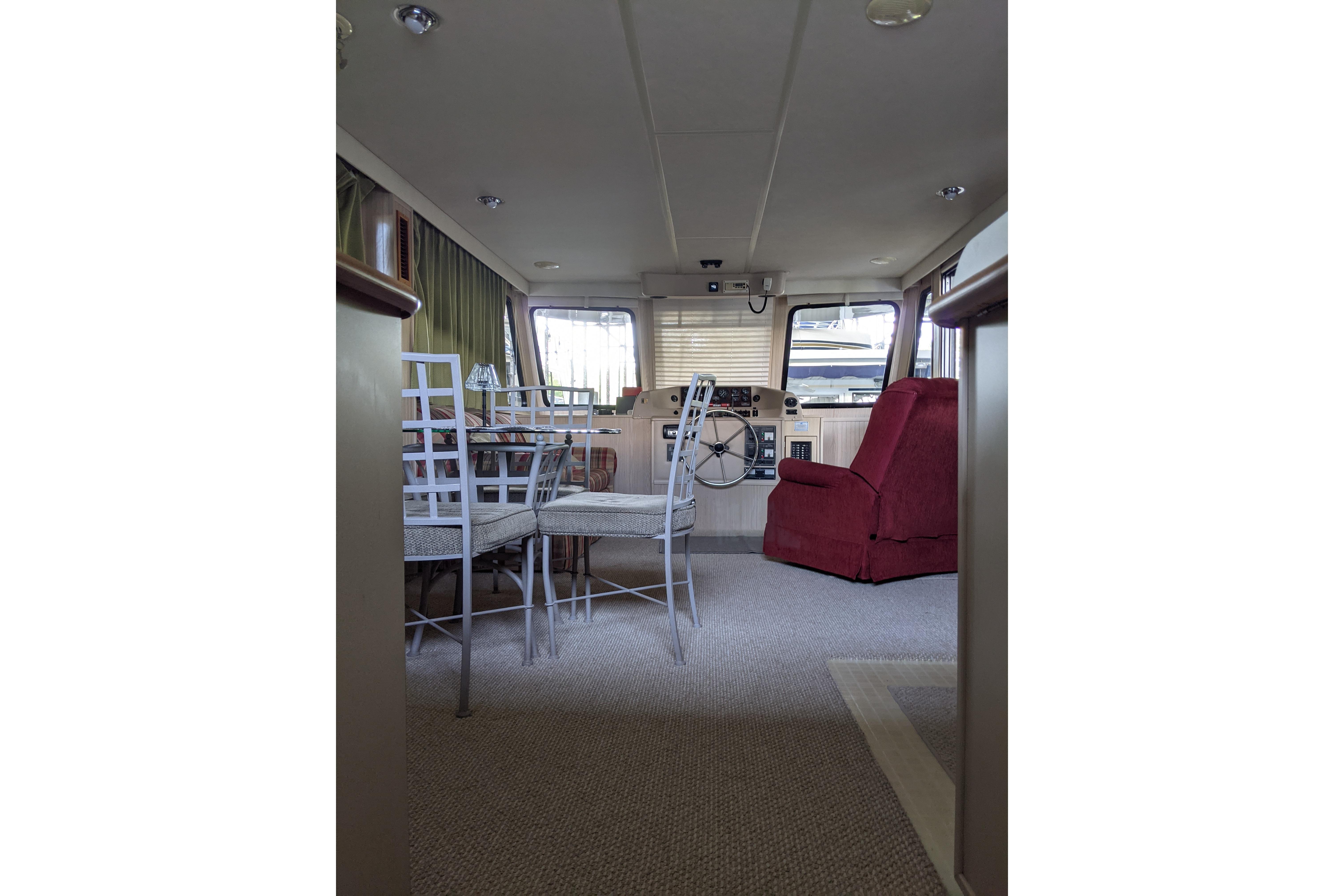 Interior of 2001 Gibson 50 Cabin Yacht with dining area and helm.