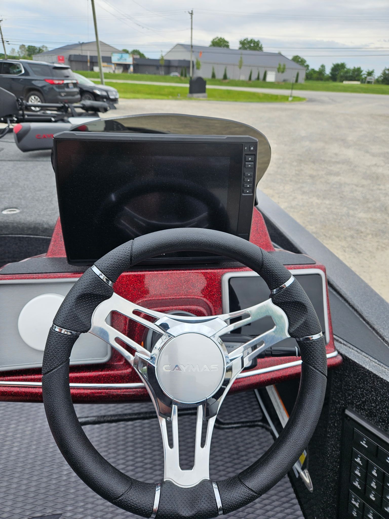 Steering wheel and dashboard of a 2027 Caymas CX 21 PRO boat.