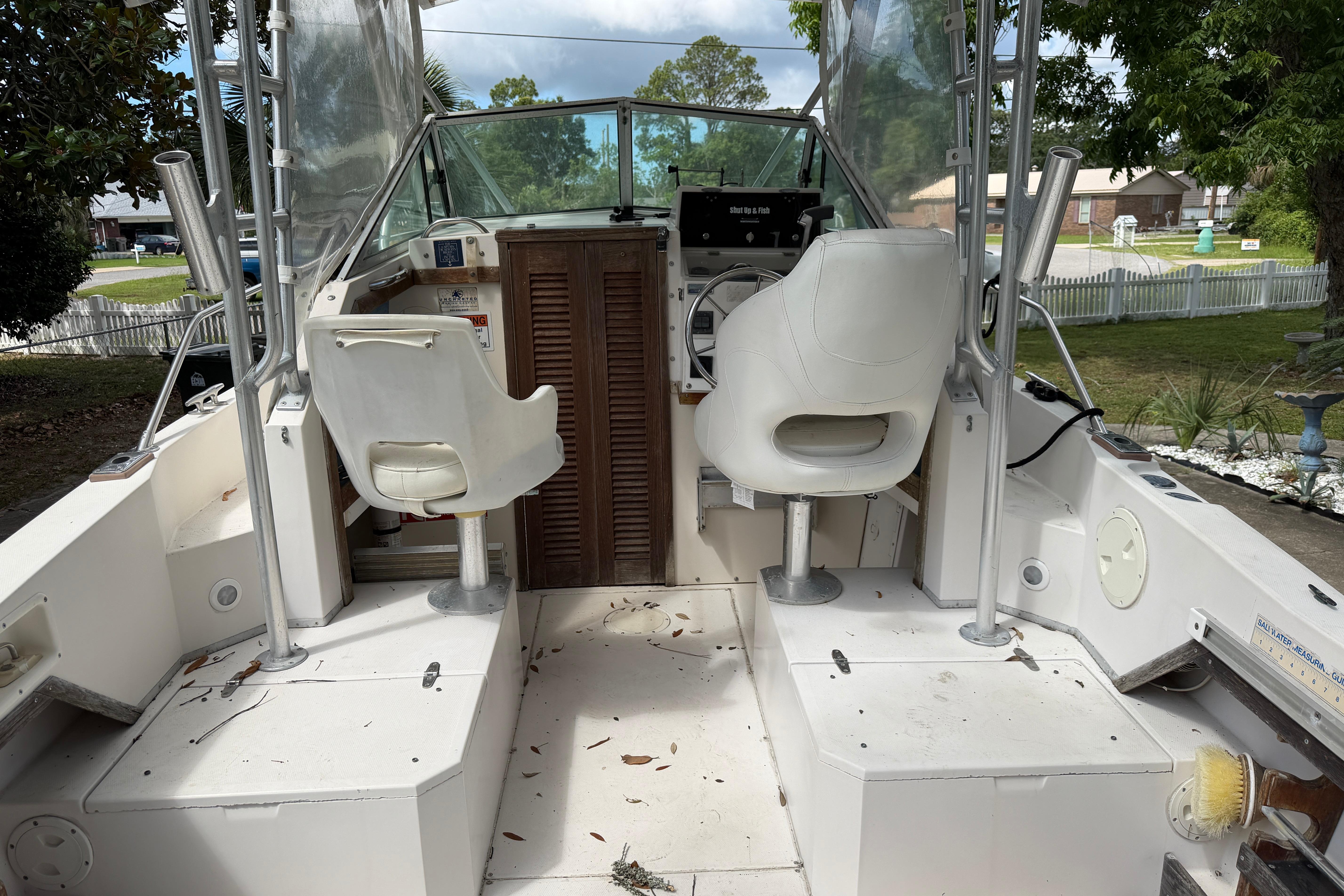 1987 Grady-White Seafarer 226 boat interior with dual white captain chairs.
