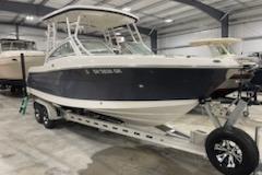 2022 Robalo R247 Dual Console boat on trailer in indoor storage facility.