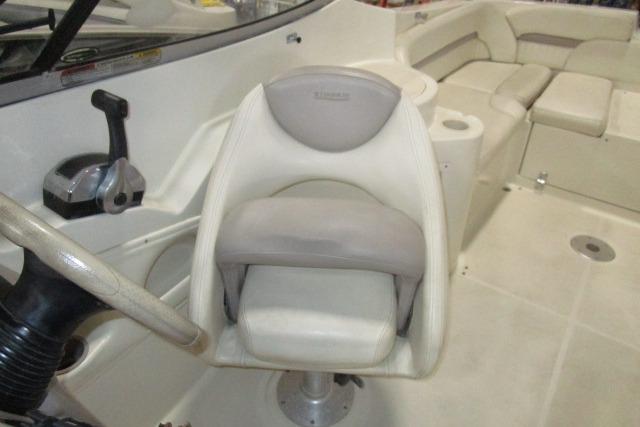 2004 Stingray 240 LR boat interior with steering wheel and seating area.