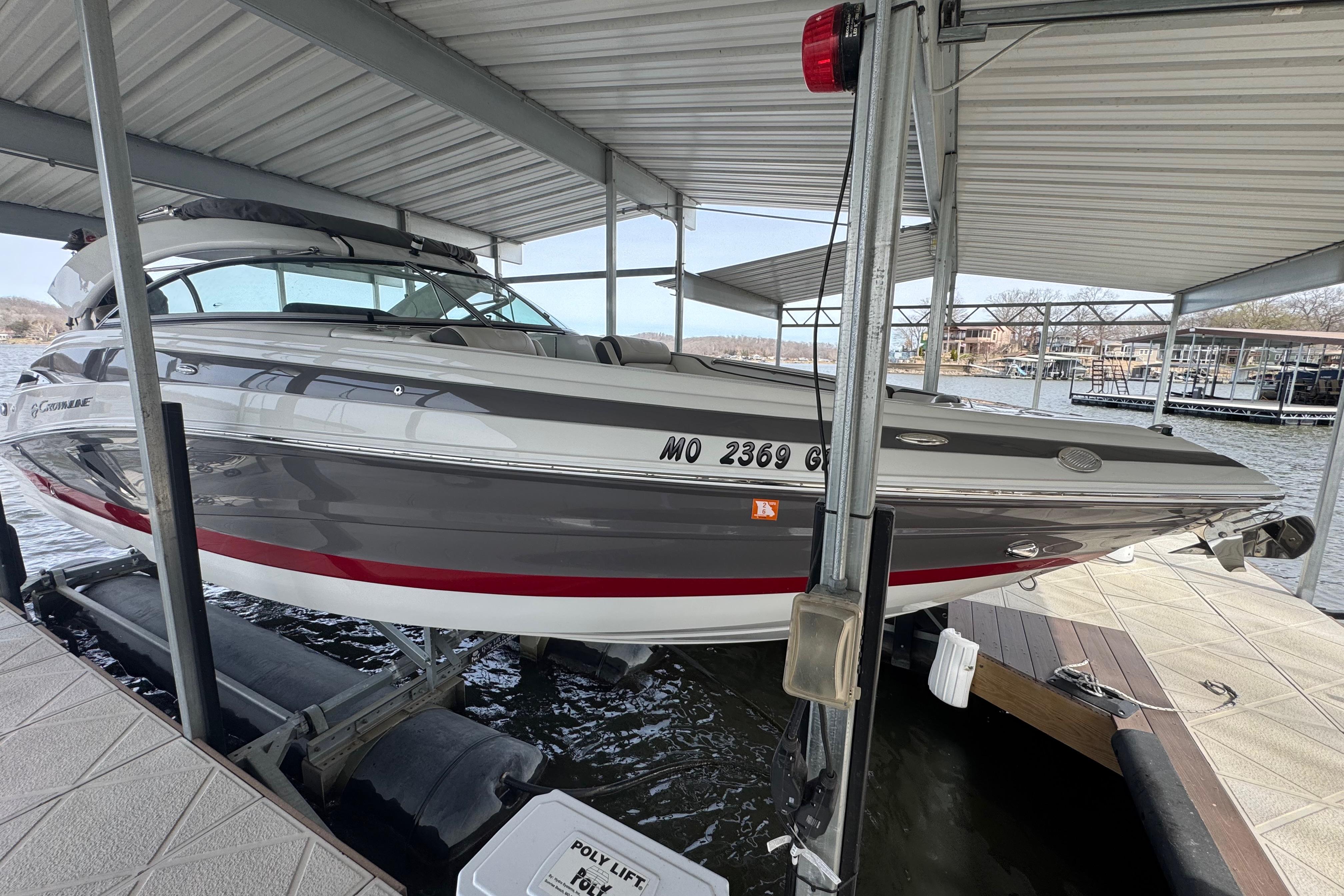 2022 Crownline 265 SS boat docked under a covered marina.