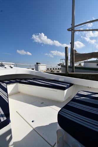 2021 Eastern 248 Center Console boat with striped seating, docked under a clear blue sky.