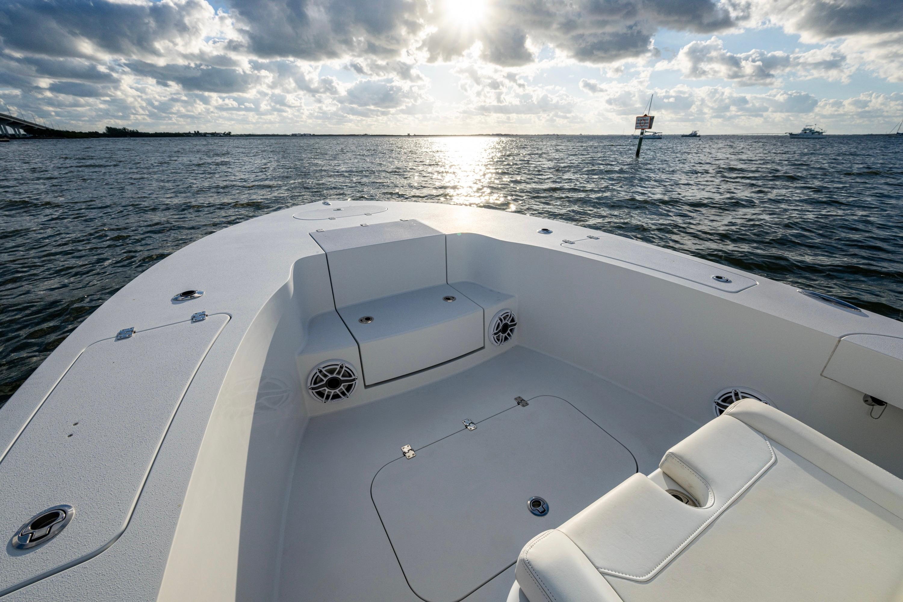 2022 Conch 25 boat interior with seating, ocean view, and cloudy sky.