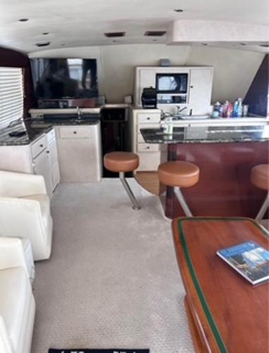 Interior of 1986 Egg Harbor 60 Sportfisherman yacht with modern kitchen and seating area.