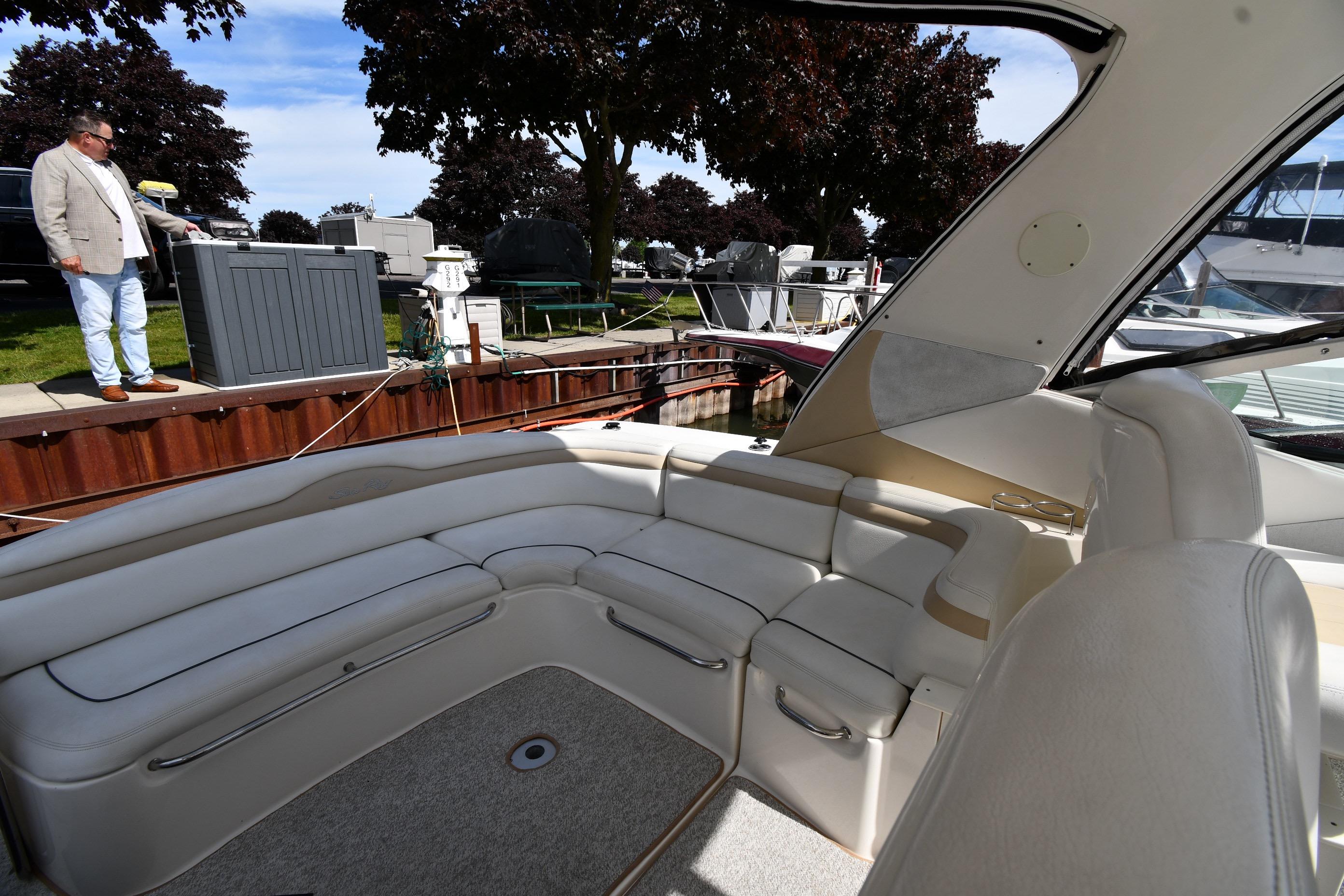 2008 Sea Ray Sundancer 350 interior with spacious seating, docked near a marina.