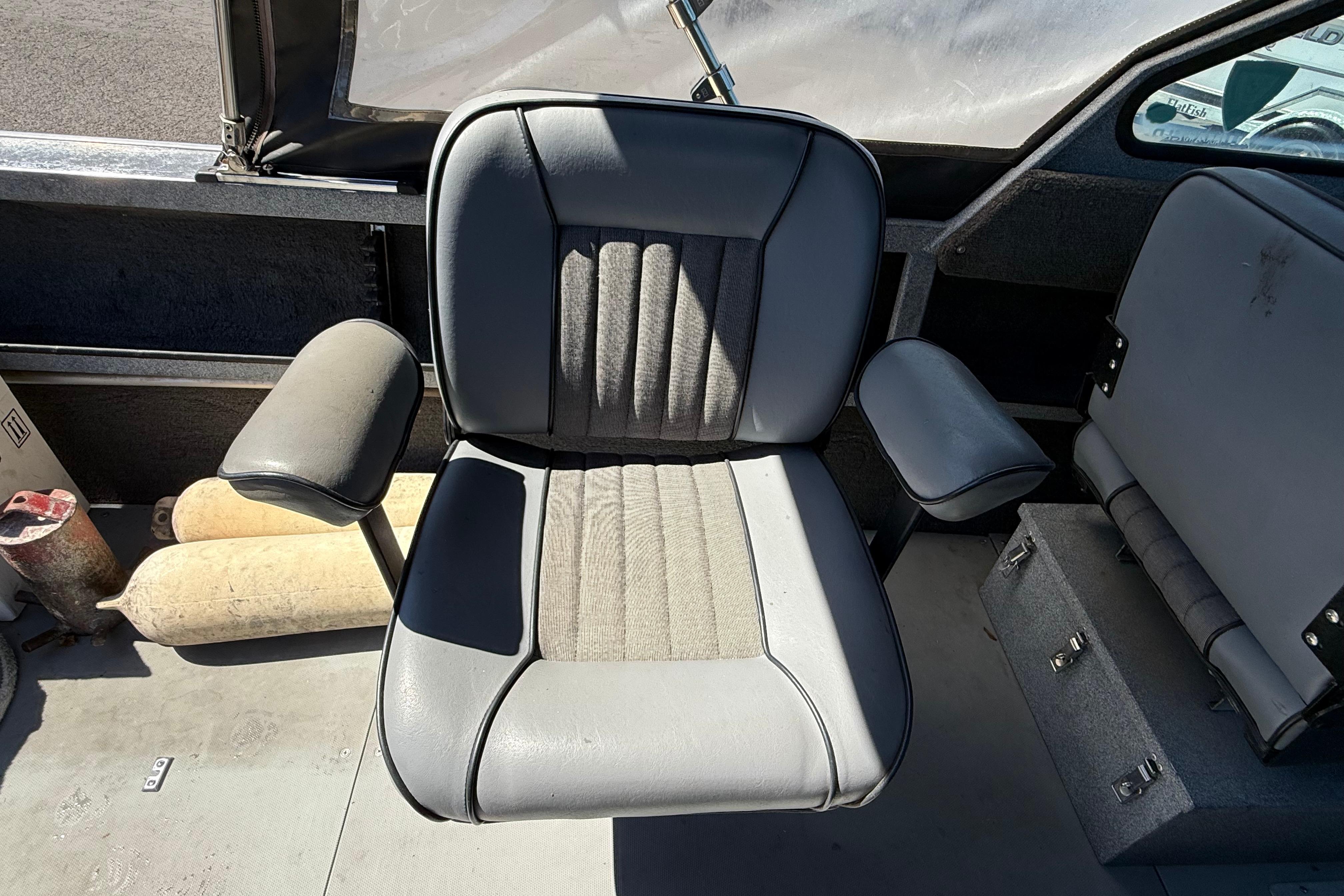2004 Alumaweld Intruder Outboard 20 boat seat, gray upholstery, armrests, and storage compartments.