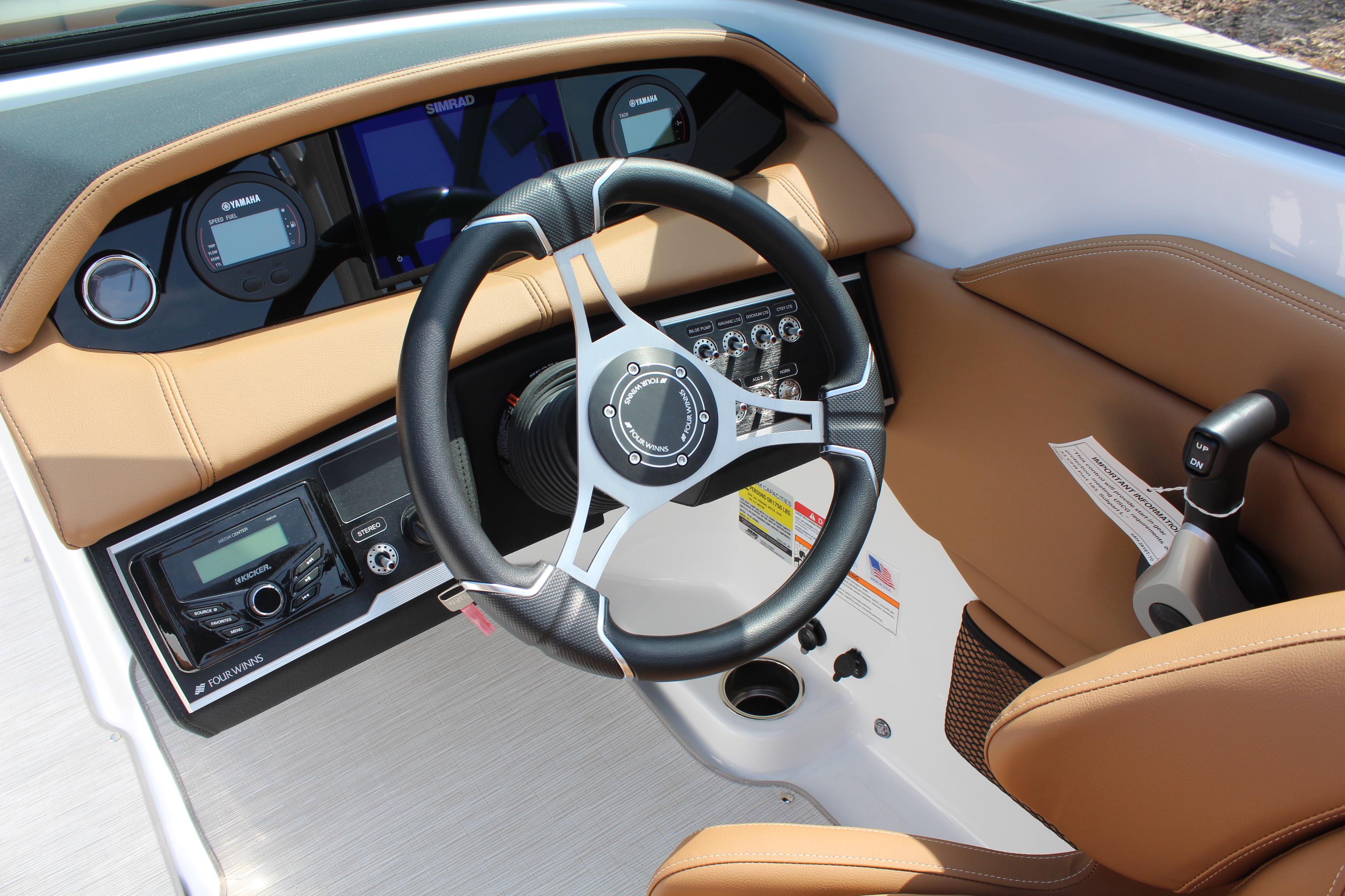 2025 Four Winns HD3 OB boat dashboard with steering wheel and control panel.