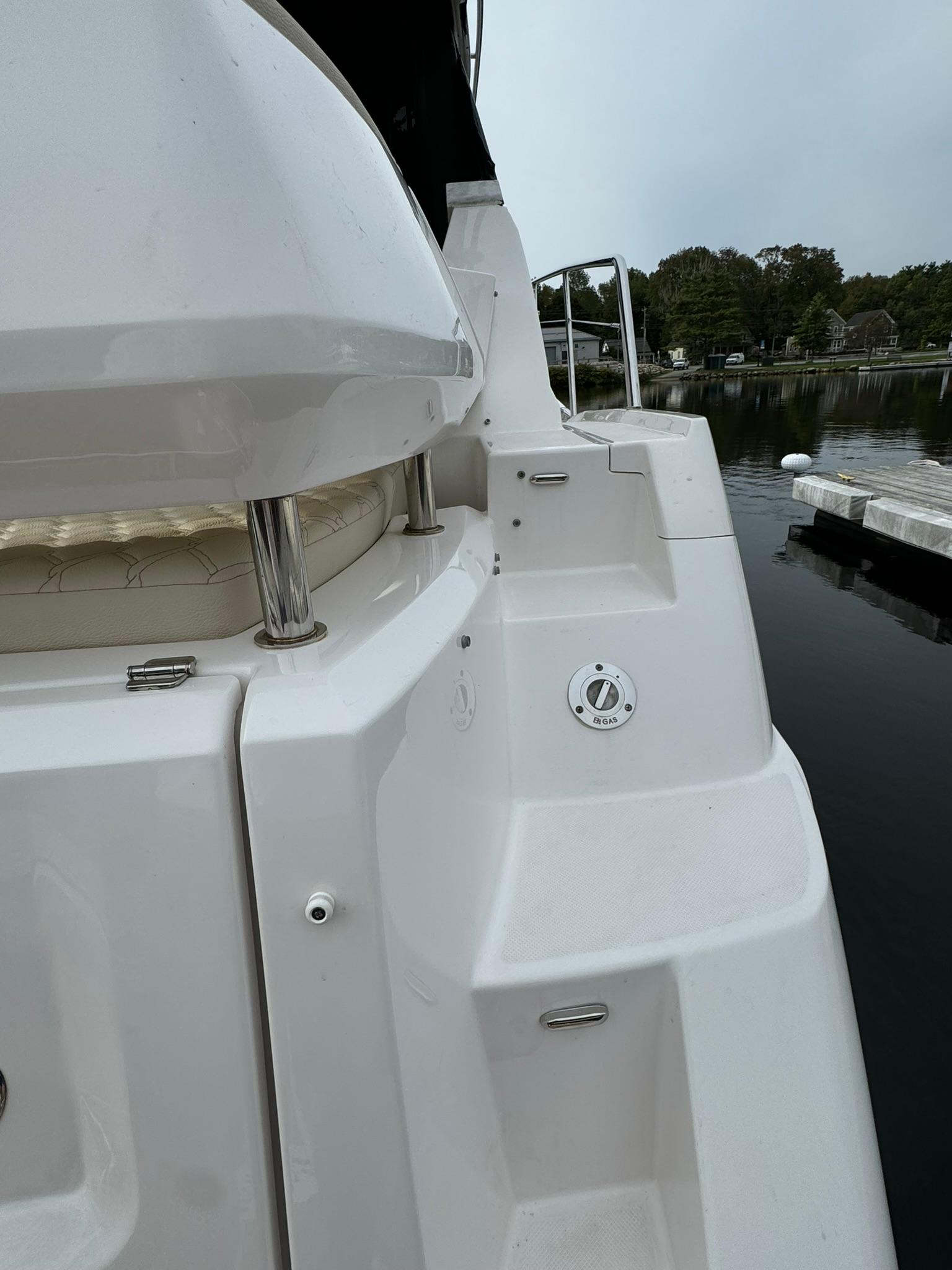 2020 Regal 38 Grande Coupe yacht stern view at a dock.