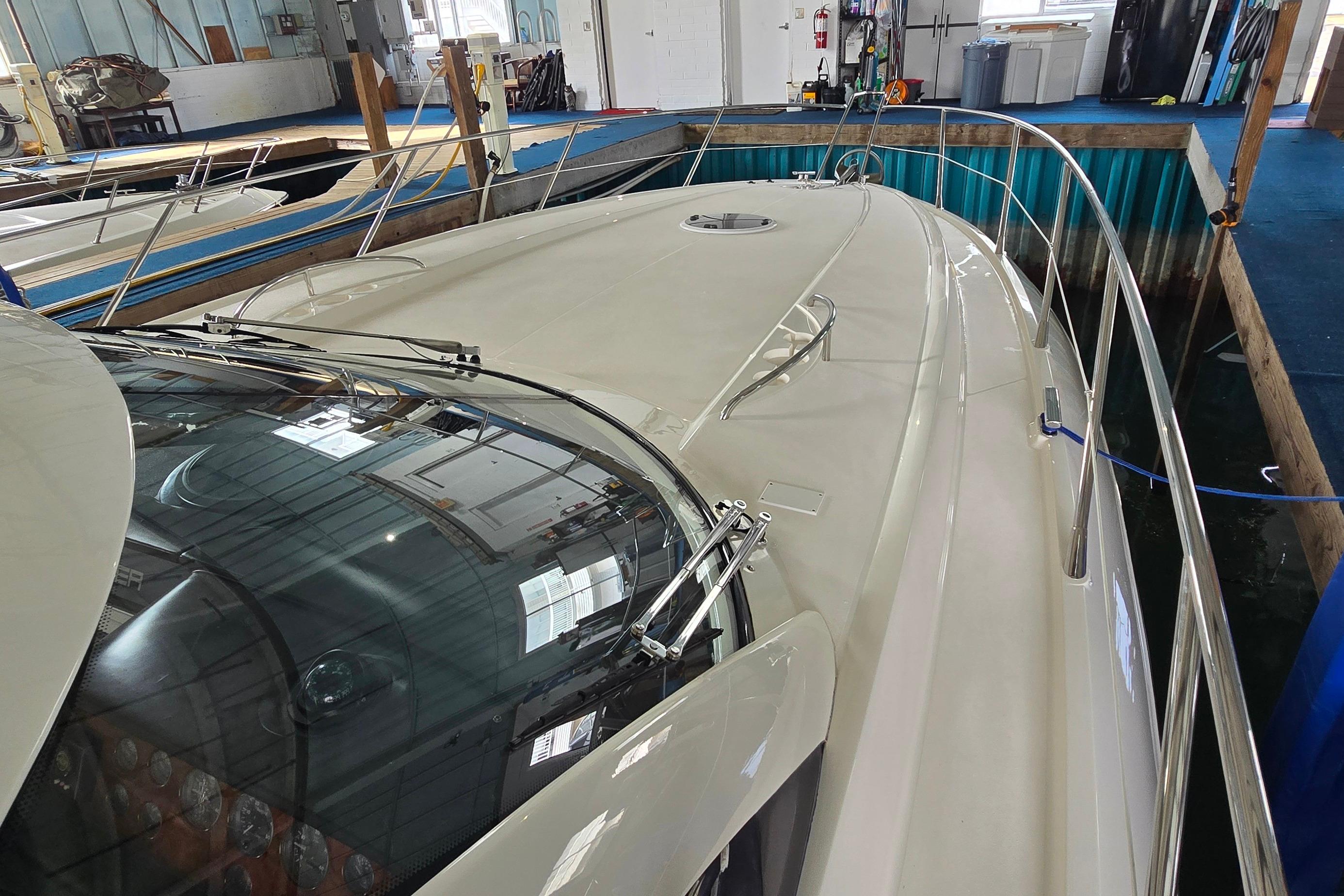 2004 Sunseeker Camargue 50 yacht docked indoors, showcasing sleek design and spacious deck.