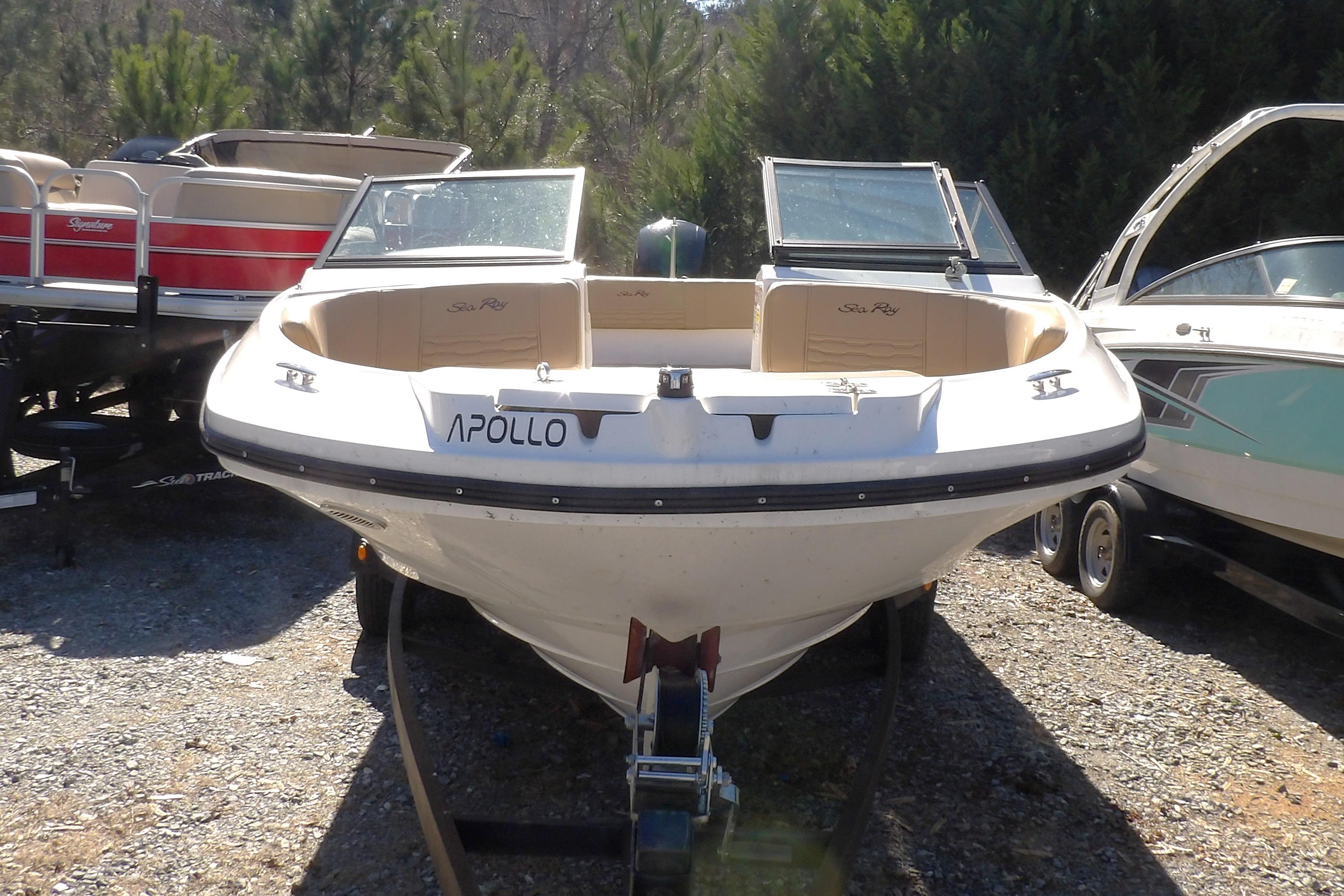 2023 Searay 210 SPO boat named Apollo, parked on gravel with trees in background.