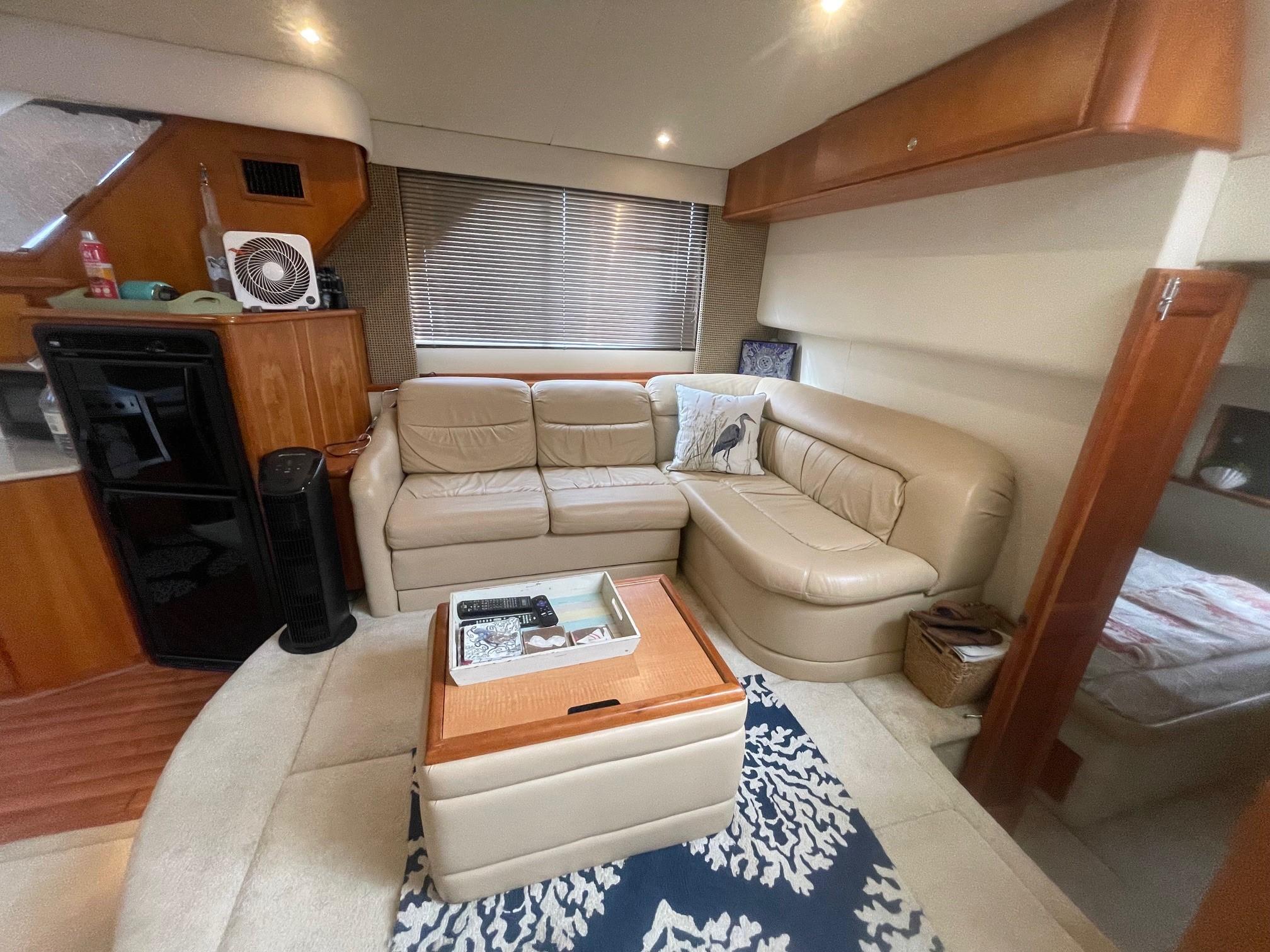 Luxurious interior of a 2002 Silverton 392 Motor Yacht with beige leather seating.