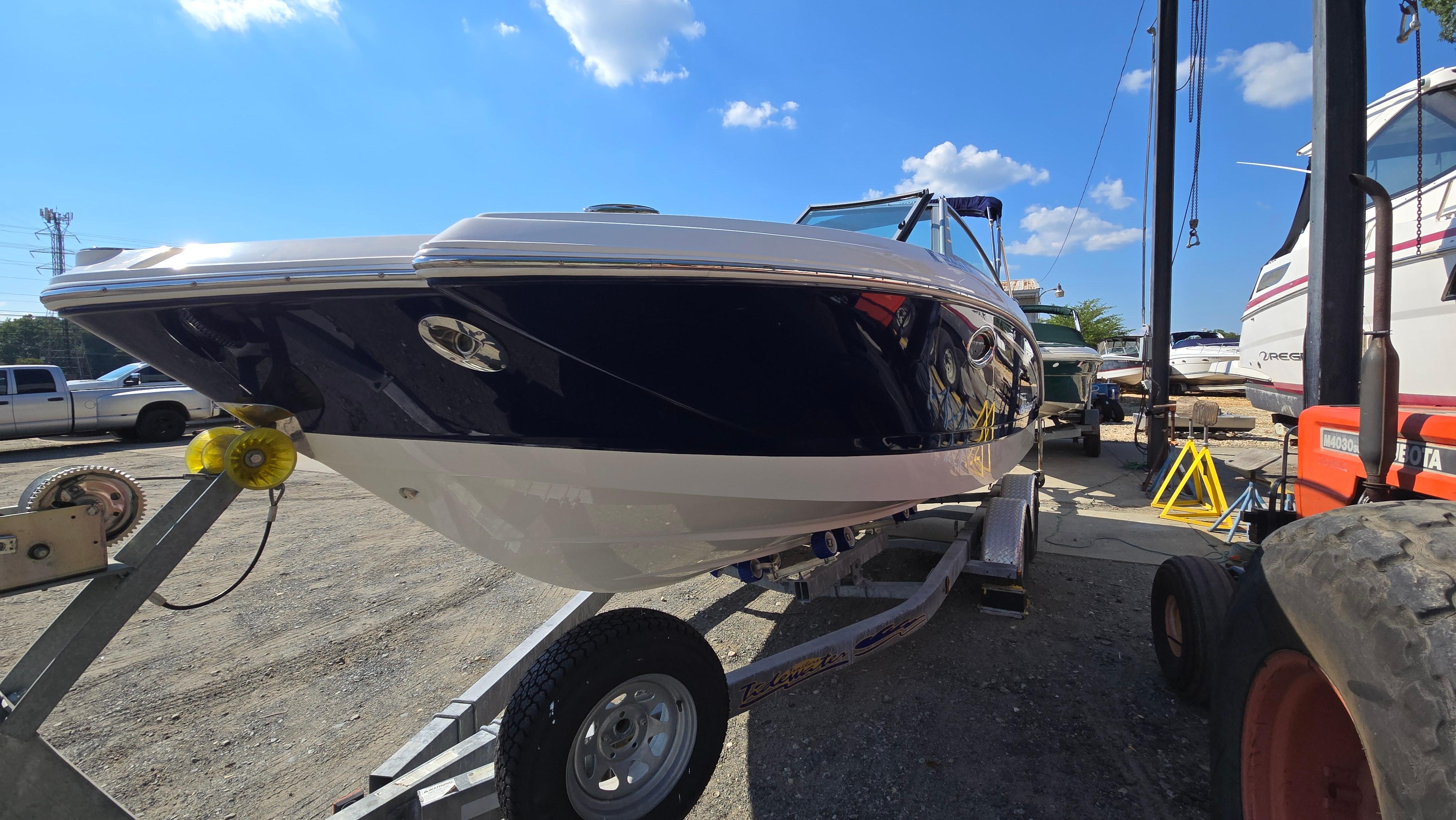 2018 Chaparral 224 Sunesta boat on trailer under clear blue sky.