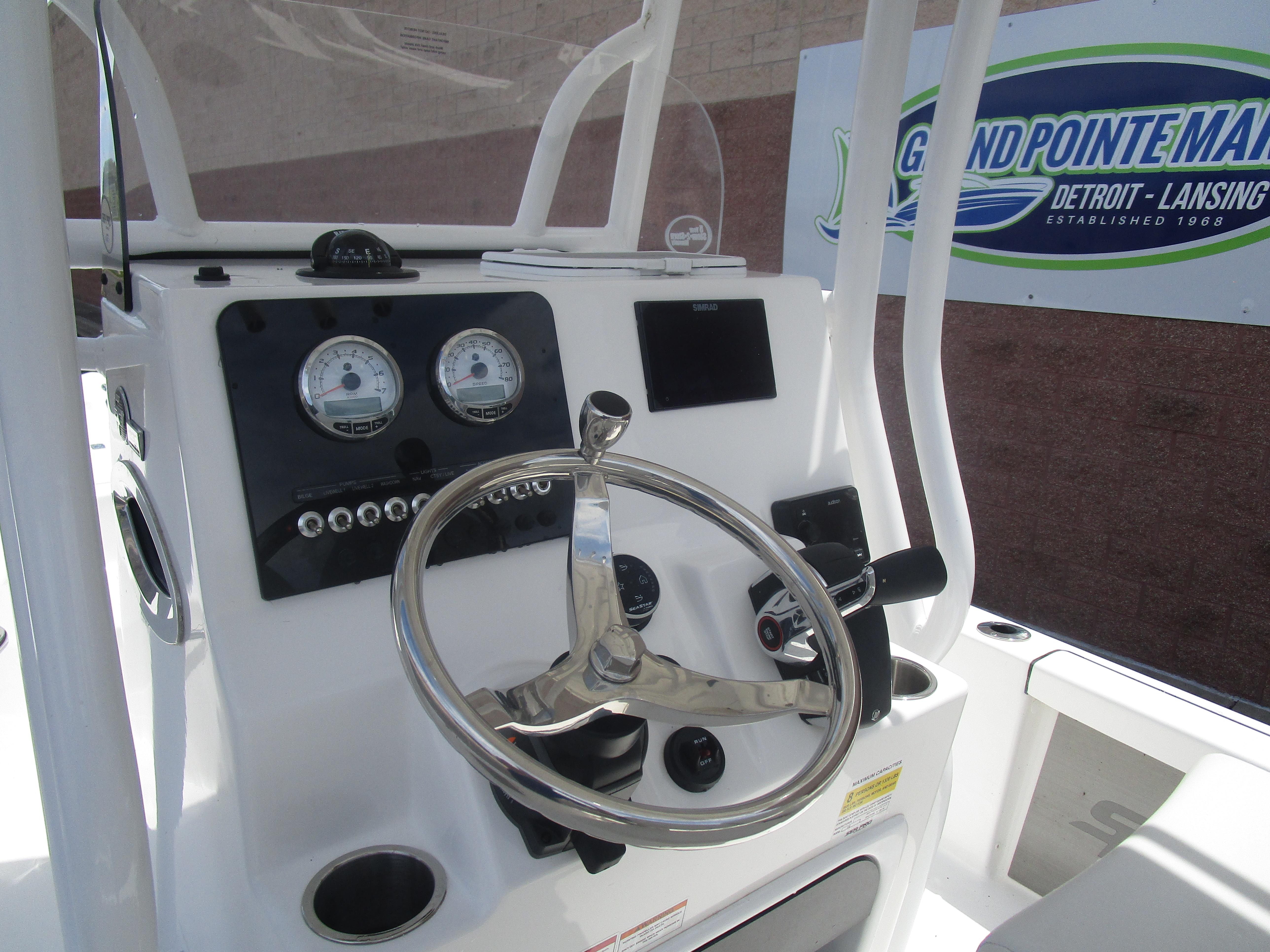 2025 Sea Pro 230 DLX BAY boat console with steering wheel and gauges.