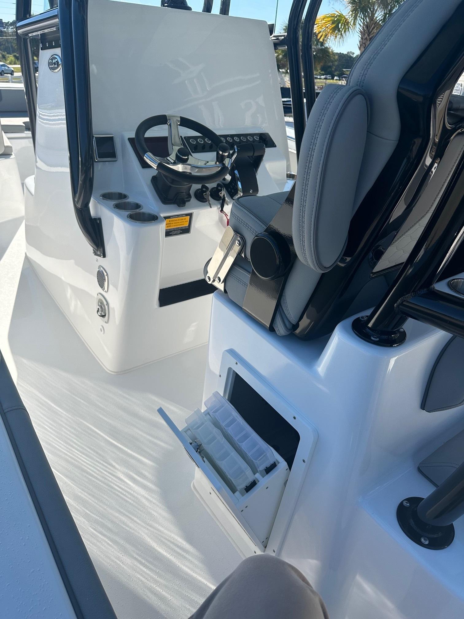 2025 Cape Horn 28XS boat interior with steering console and storage compartments.