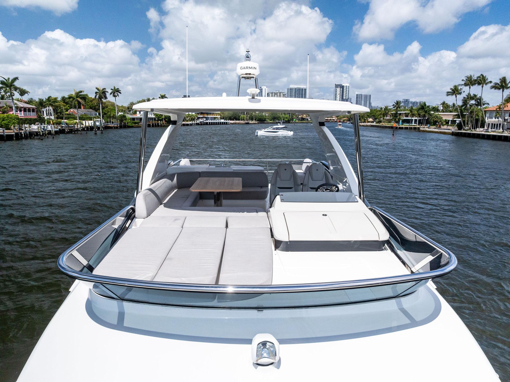 2023 Absolute 52 FLY yacht on water, featuring spacious deck and luxurious seating.