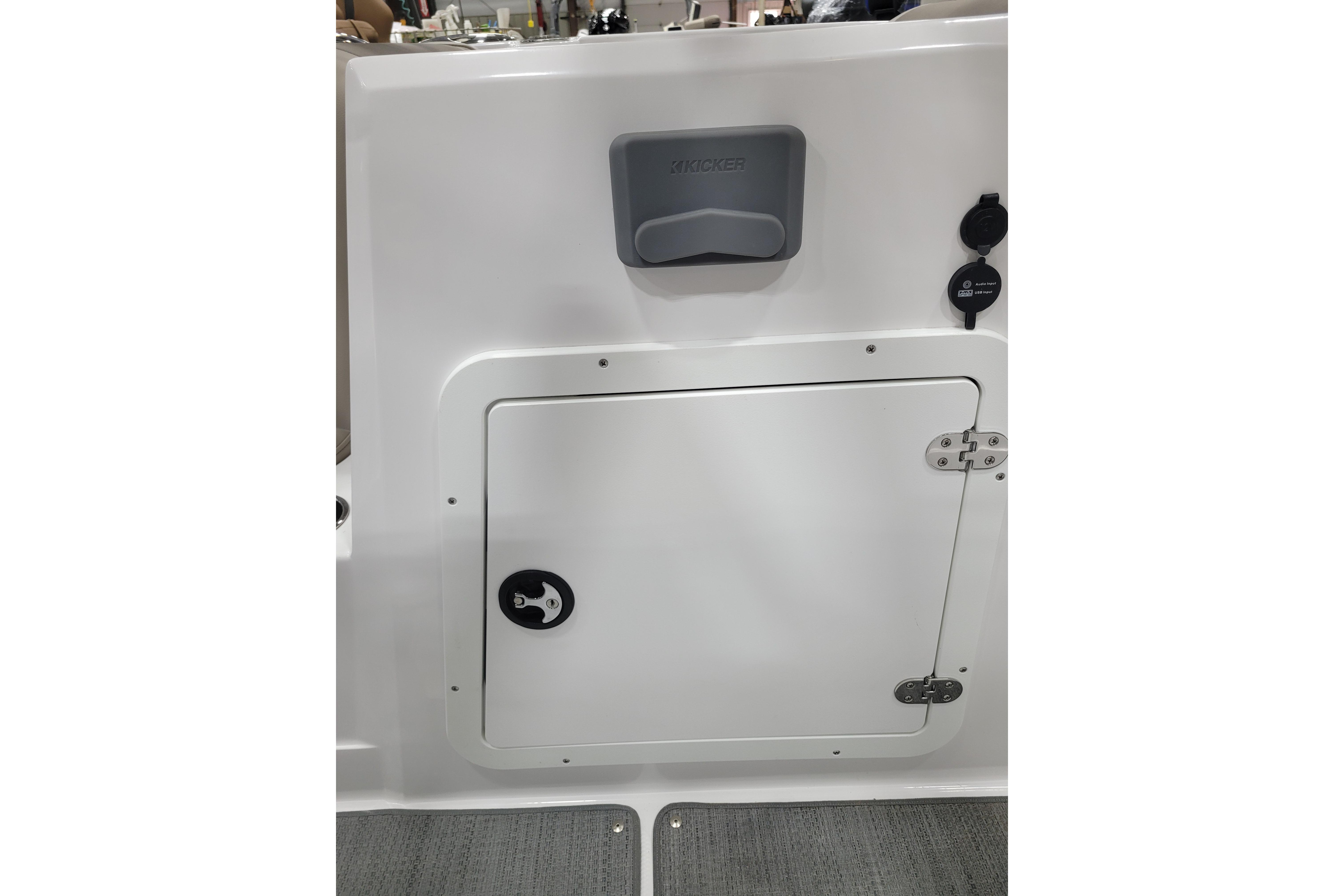 2026 Tahoe 2150 boat interior with storage compartment and audio system.