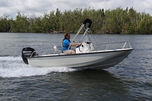 Manufacturer Provided Image: 2026 Boston Whaler 150 Montauk boat cruising on a lake with a person steering.