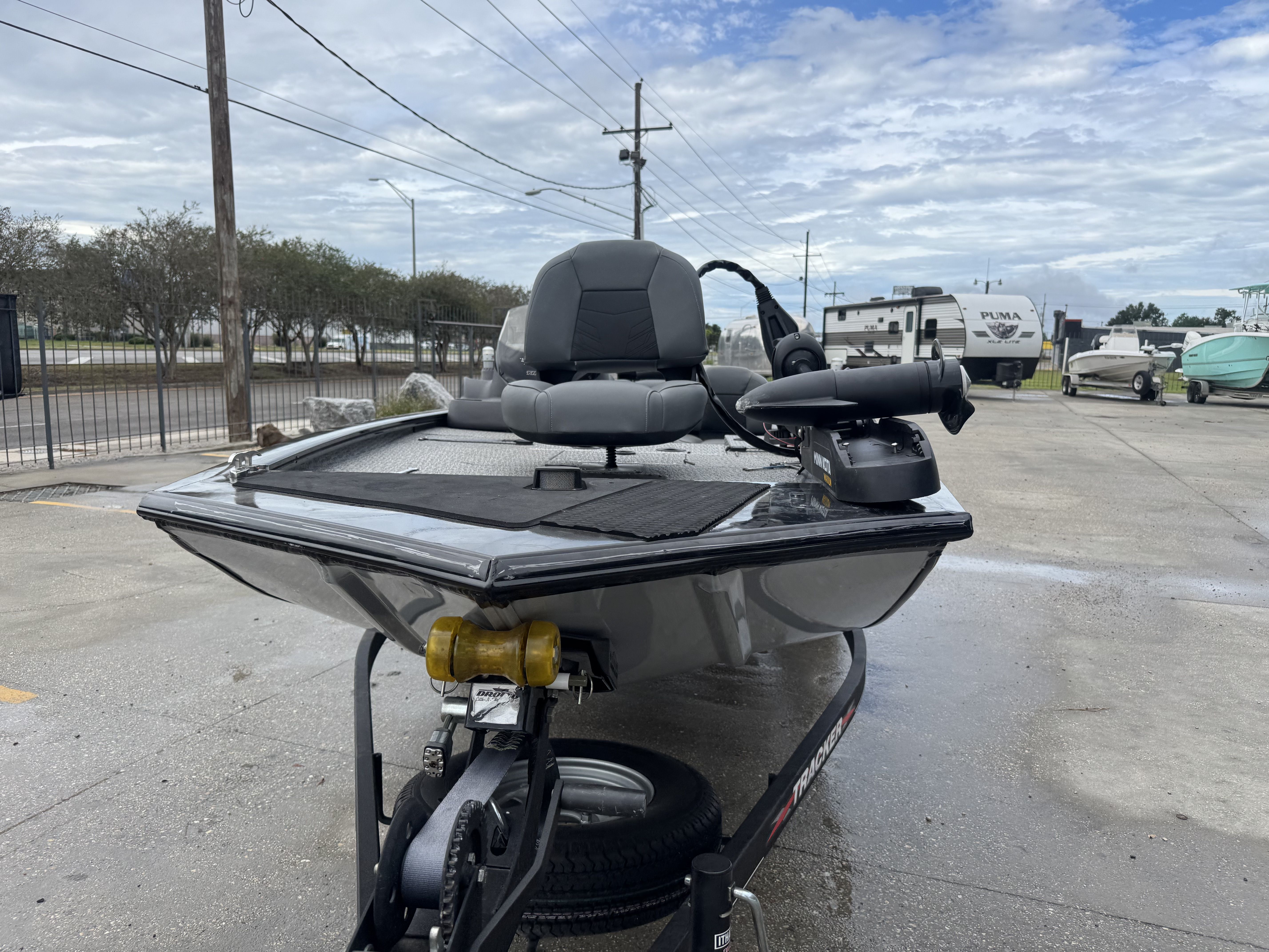 2024 Tracker Pro 170 boat on trailer, parked outdoors under cloudy sky.