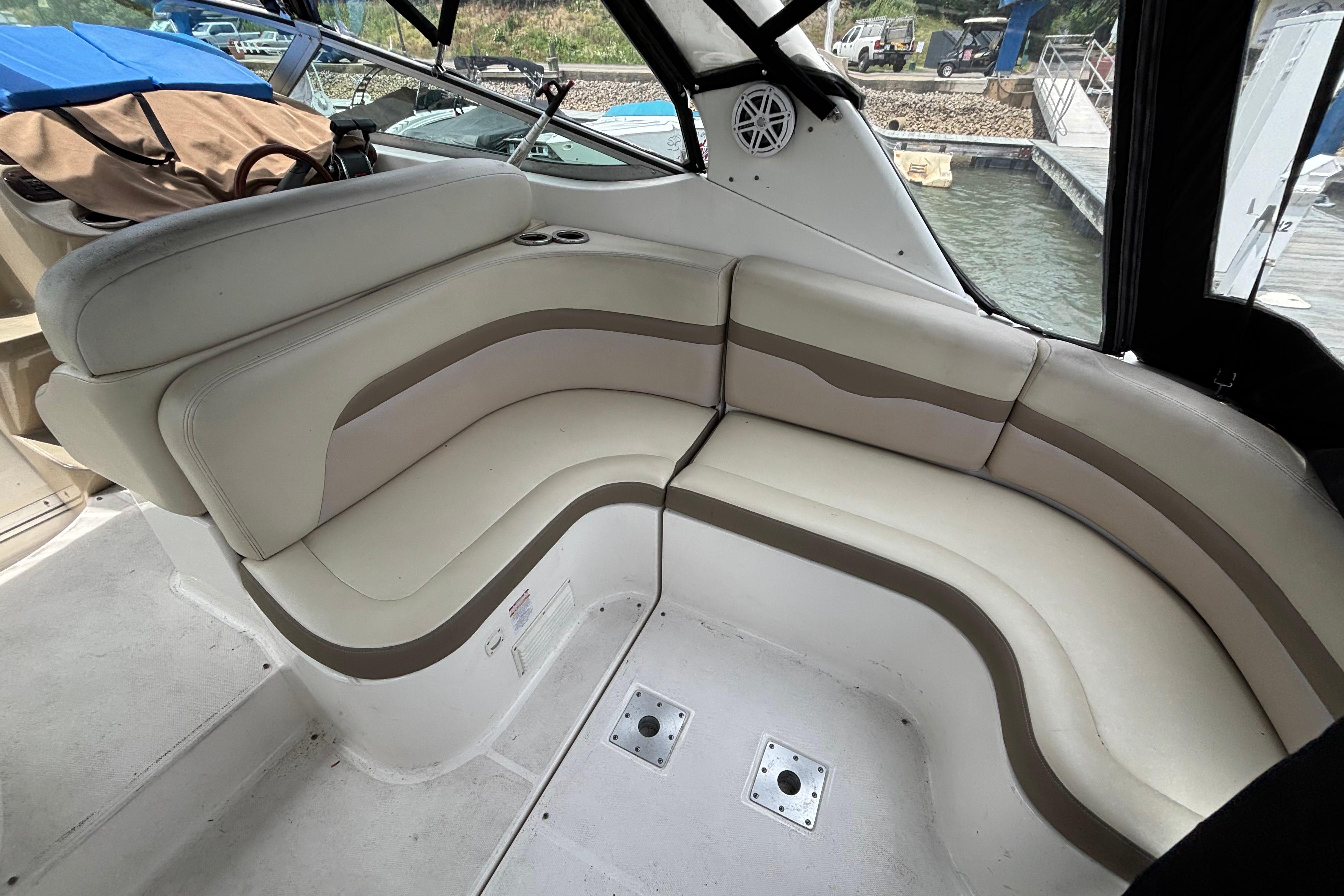 2004 Chaparral Signature 330 boat interior with curved seating and cup holders.