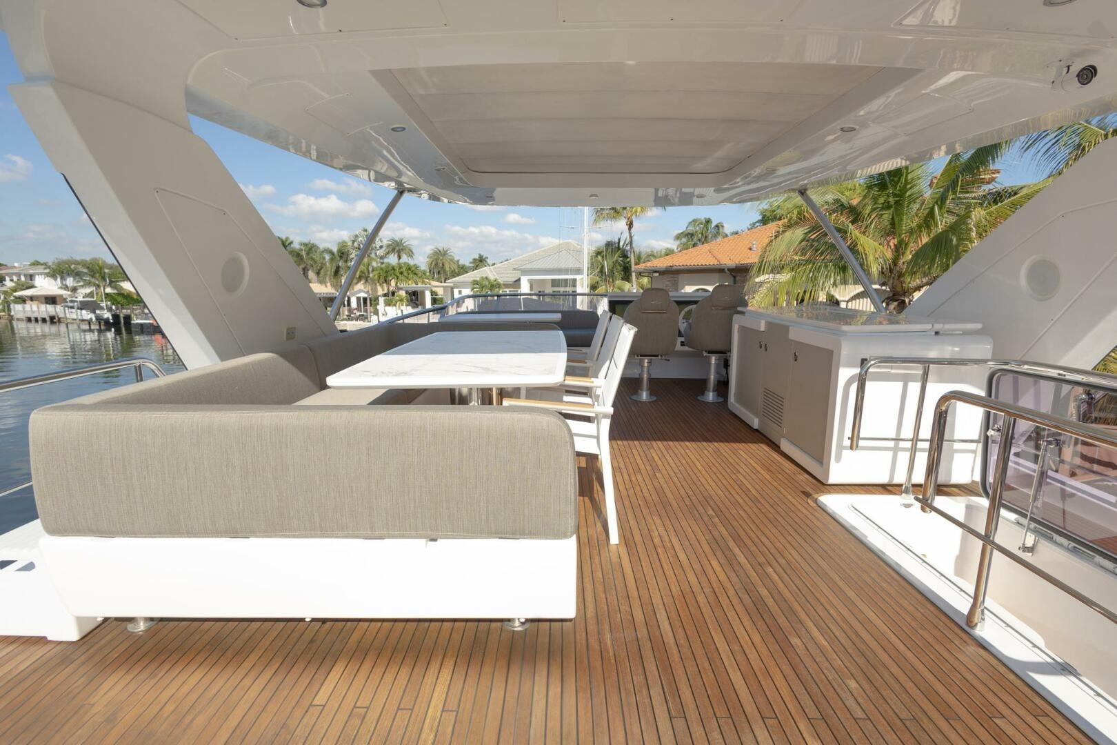 Luxurious 2021 Azimut Fly 72 yacht deck with elegant seating and wooden flooring.