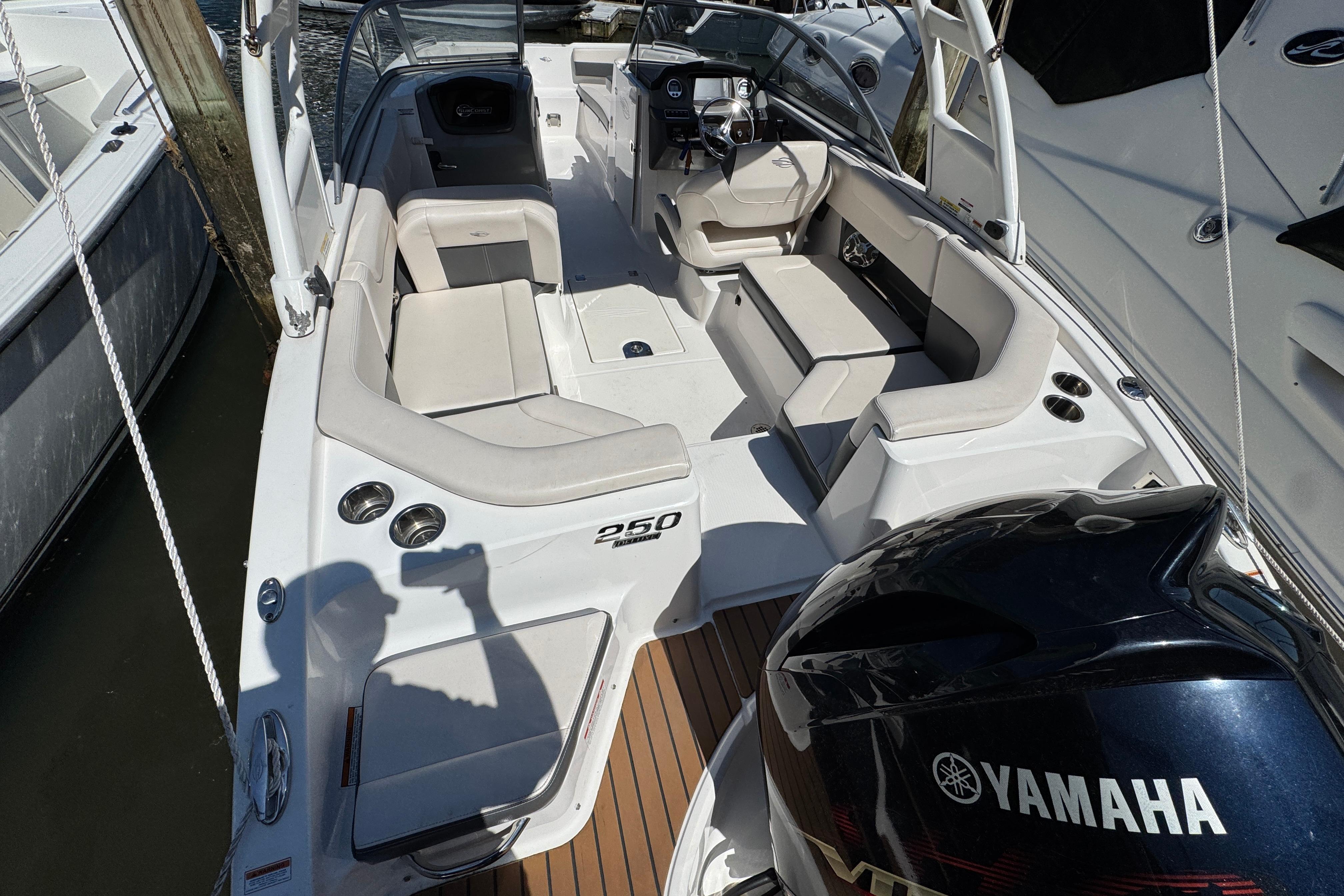 2018 Chaparral 250 Suncoast boat with Yamaha engine, featuring spacious seating and sleek design.