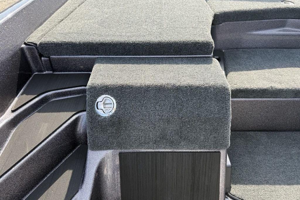Interior view of 2026 Skeeter ZXE20 boat with carpeted surfaces and storage compartment.