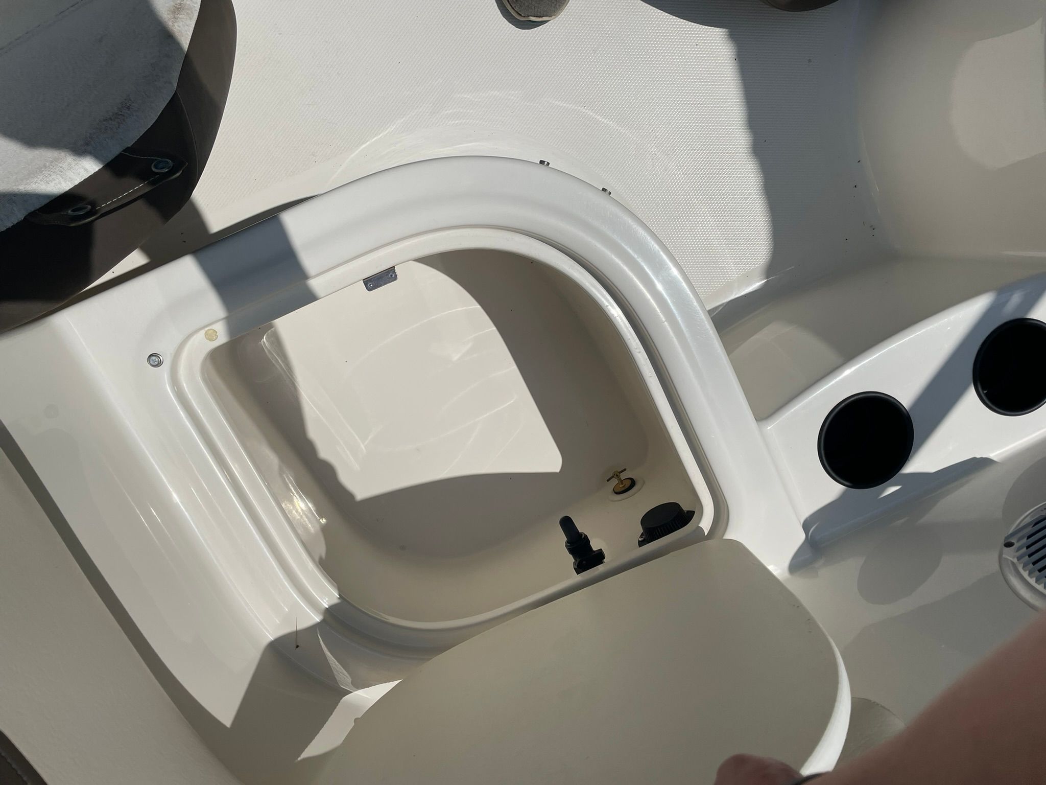 Close-up of a white boat cabin area with round cup holders.