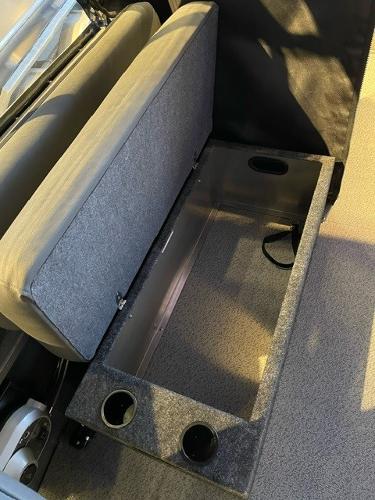 2024 Spartan 185 Astoria boat storage compartment with cushioned seat and cup holders.