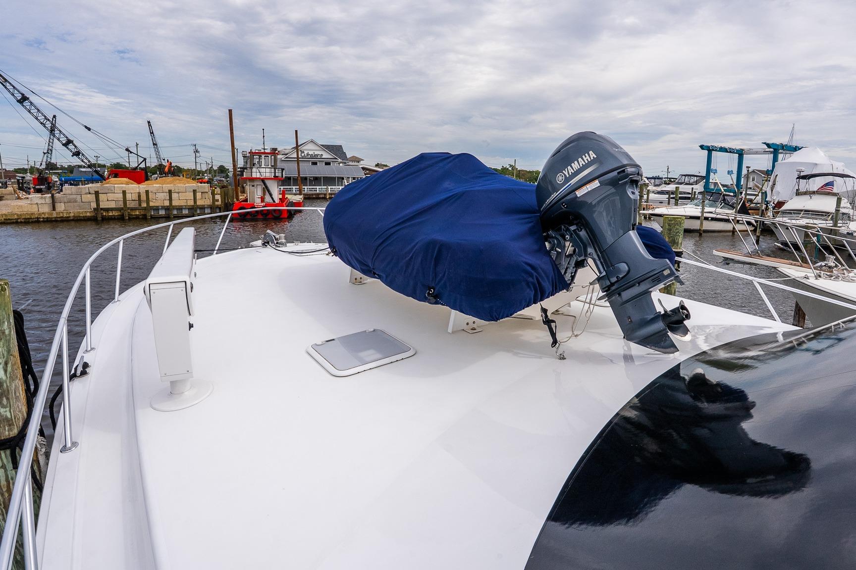 2002 Viking 61 Enclosed Bridge yacht with Yamaha motor at marina.