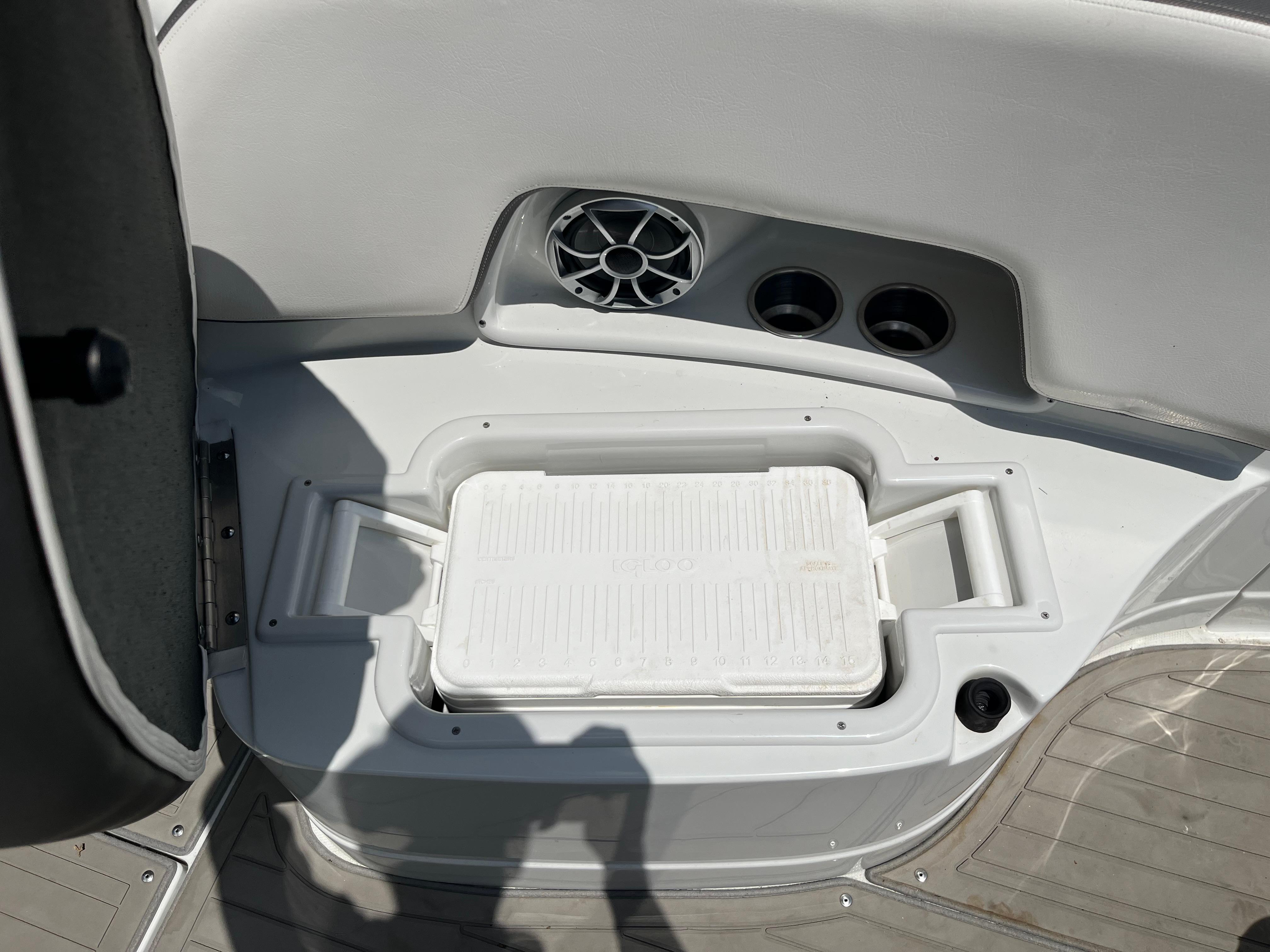 Interior of 2022 Crownline 280 SS boat with built-in cooler and speaker.