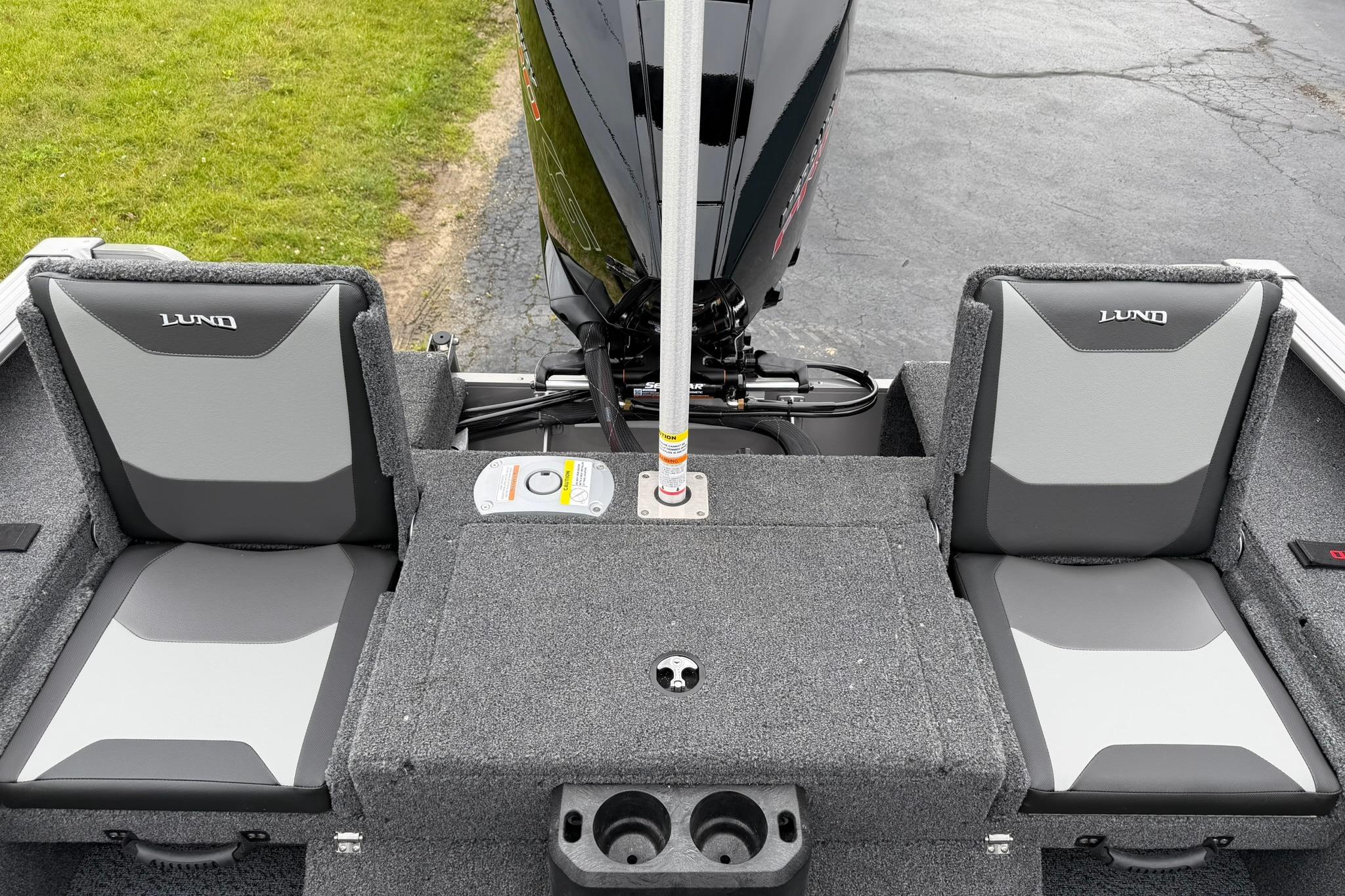 2027 Lund 2075 Impact XS boat interior with gray seating and motor.