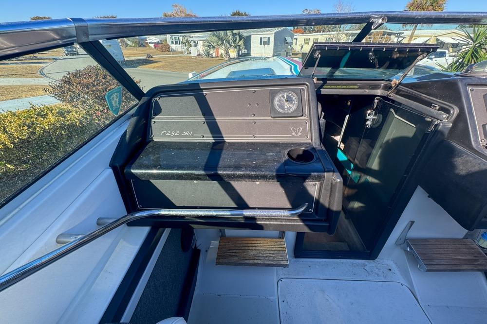 1989 Formula 292 SR-1 boat cockpit with dashboard and open cabin door.