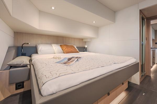 Luxurious bedroom interior of 2025 Privilege Signature 650 yacht, featuring modern design and cozy bedding.