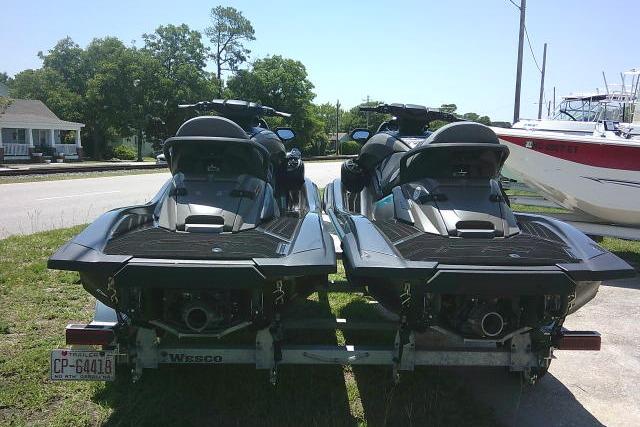 2023 Yamaha FX Cruiser HO jet skis on a trailer, parked outdoors.