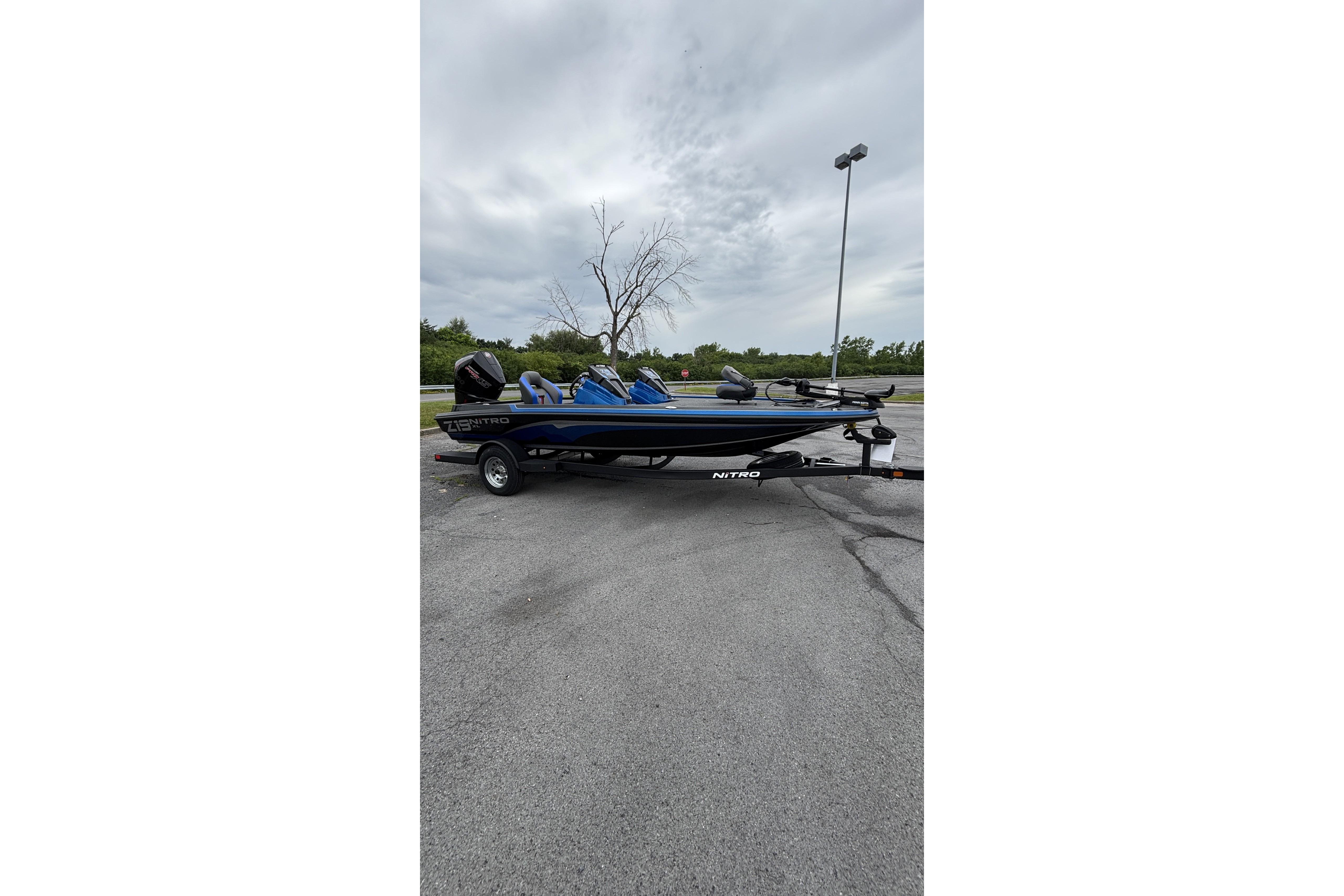 2026 Nitro Z19 XL boat on trailer in parking lot, overcast sky.