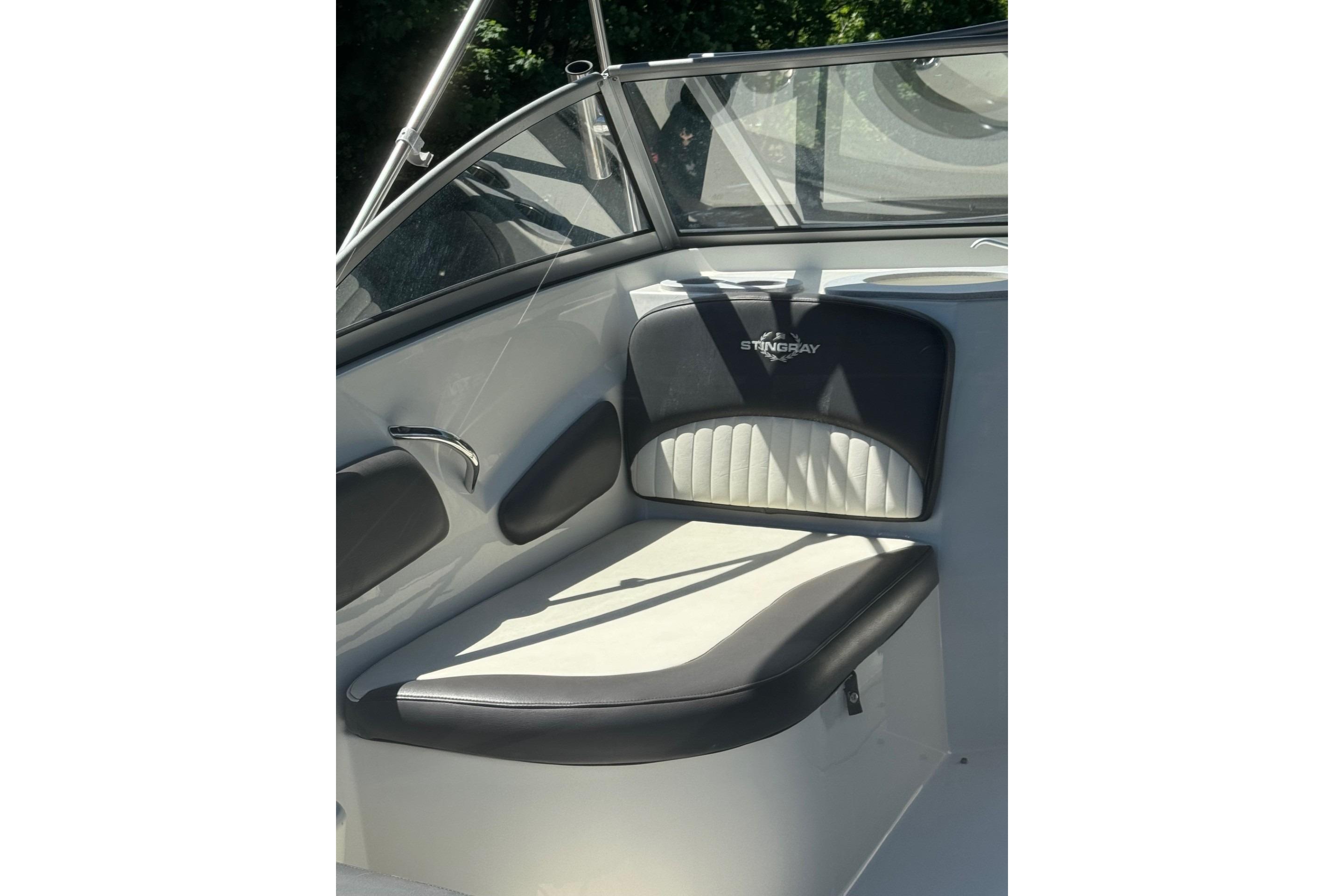 2018 Stingray 201 DC boat interior with cushioned seating and sleek design.