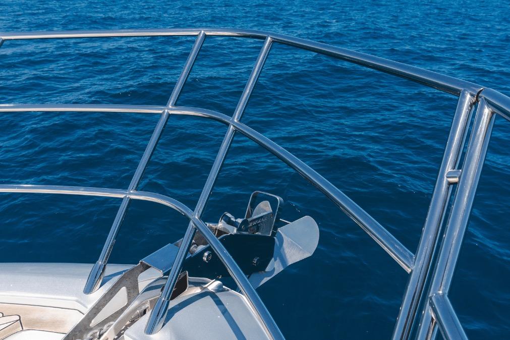 Bow view of 2020 Azimut 60 yacht with stainless steel railings over blue ocean.