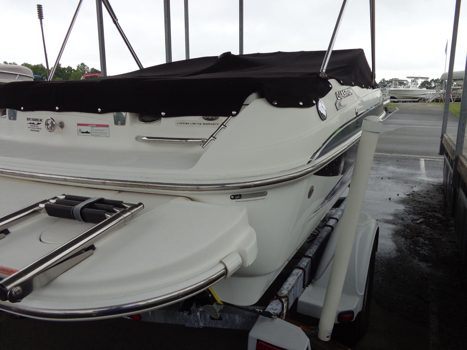2009 Glastron GT 185 boat with black cover on trailer.