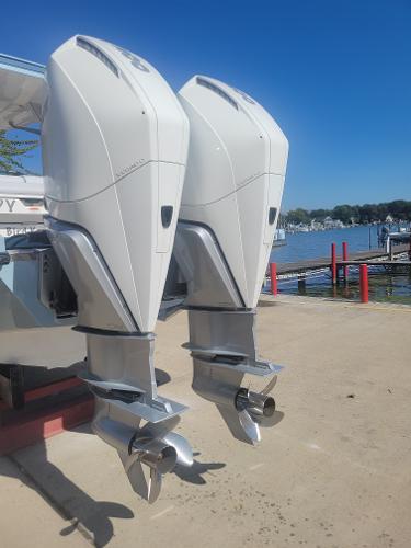 2022 Aviara AV32 OB outboard motors by the waterfront.