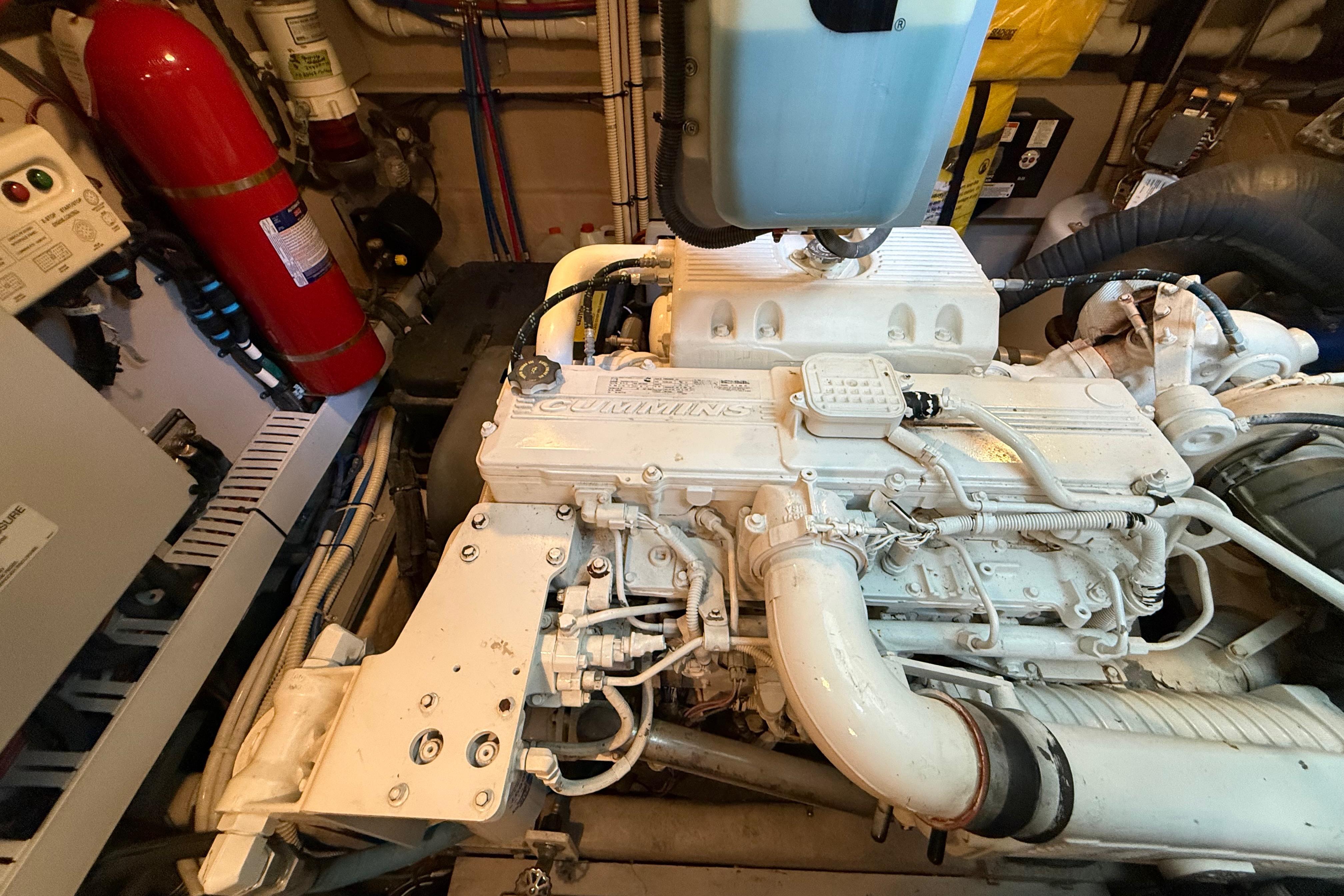 Engine room of 2016 Sea Ray Sundancer 510 with Cummins engine and fire extinguisher.