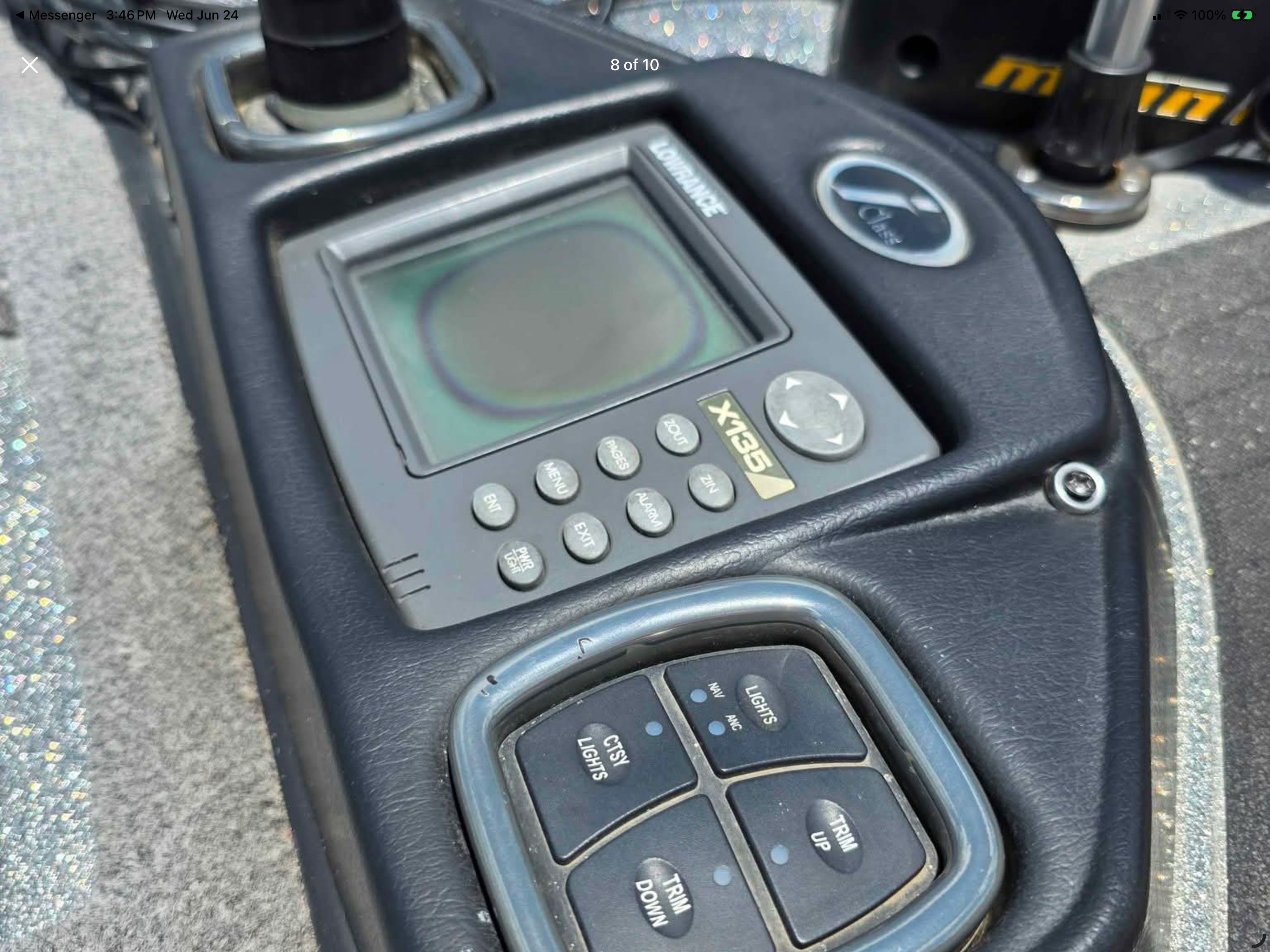 Close-up of a boat control system with a screen and several buttons.