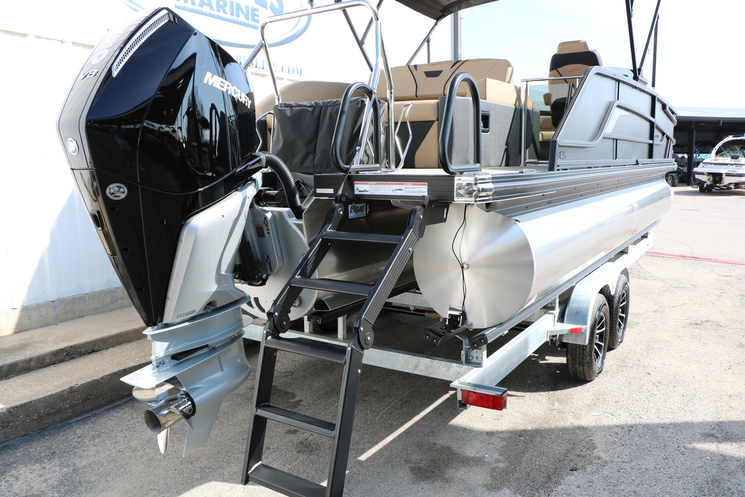2026 Evotti 723CS pontoon boat with Mercury outboard engine on trailer.