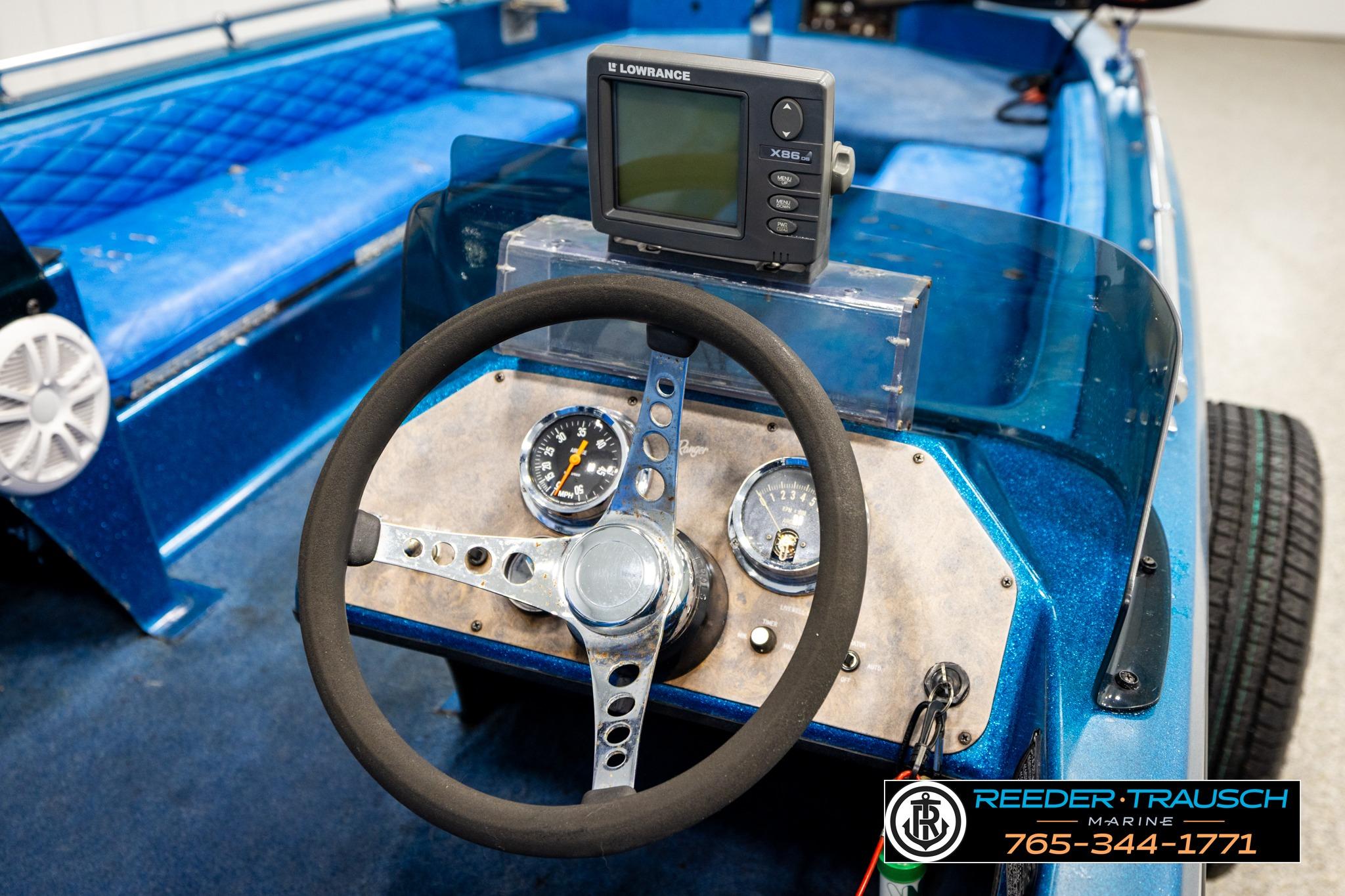 1980 Ranger 175 VS boat dashboard with steering wheel and Lowrance fish finder.