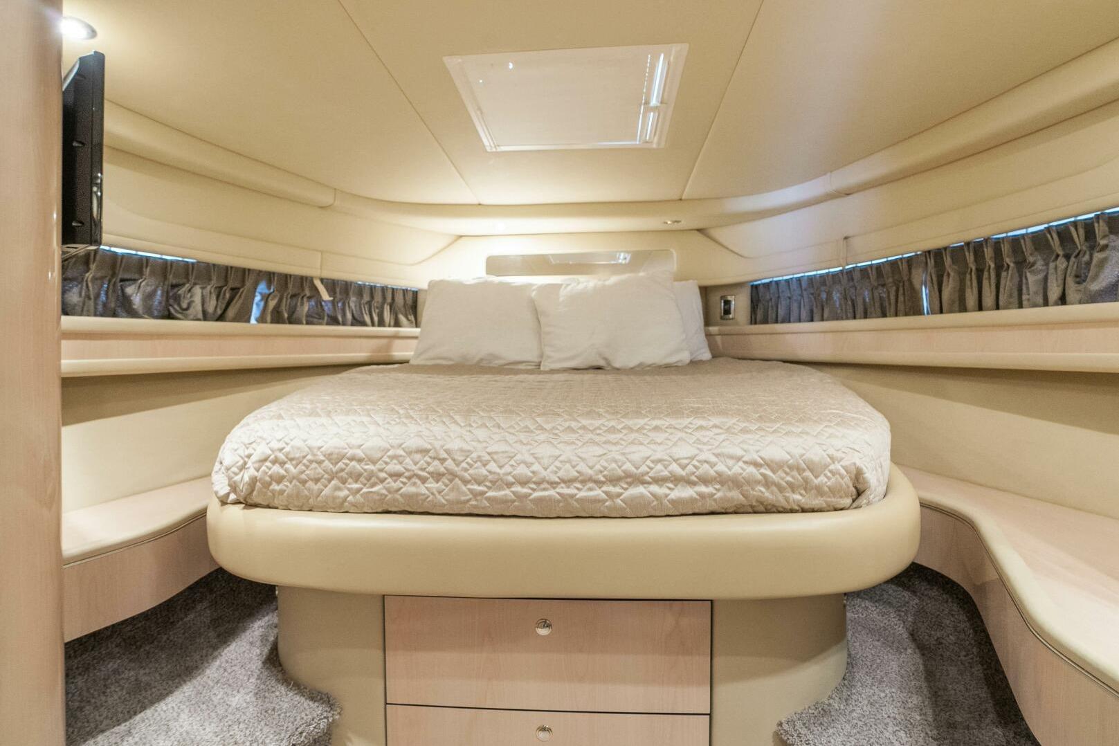 Luxurious cabin interior of 2003 Sea Ray Sundancer 460 yacht with cozy bed.