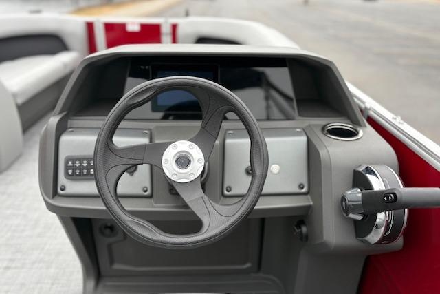 2026 Sun Tracker Party Barge 18 DLX steering console with modern controls and seating.