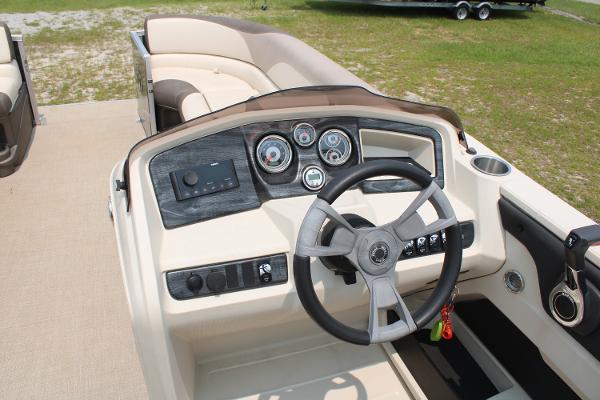 2021 Tahoe LTZ Cruise boat dashboard with steering wheel and gauges, beige interior.