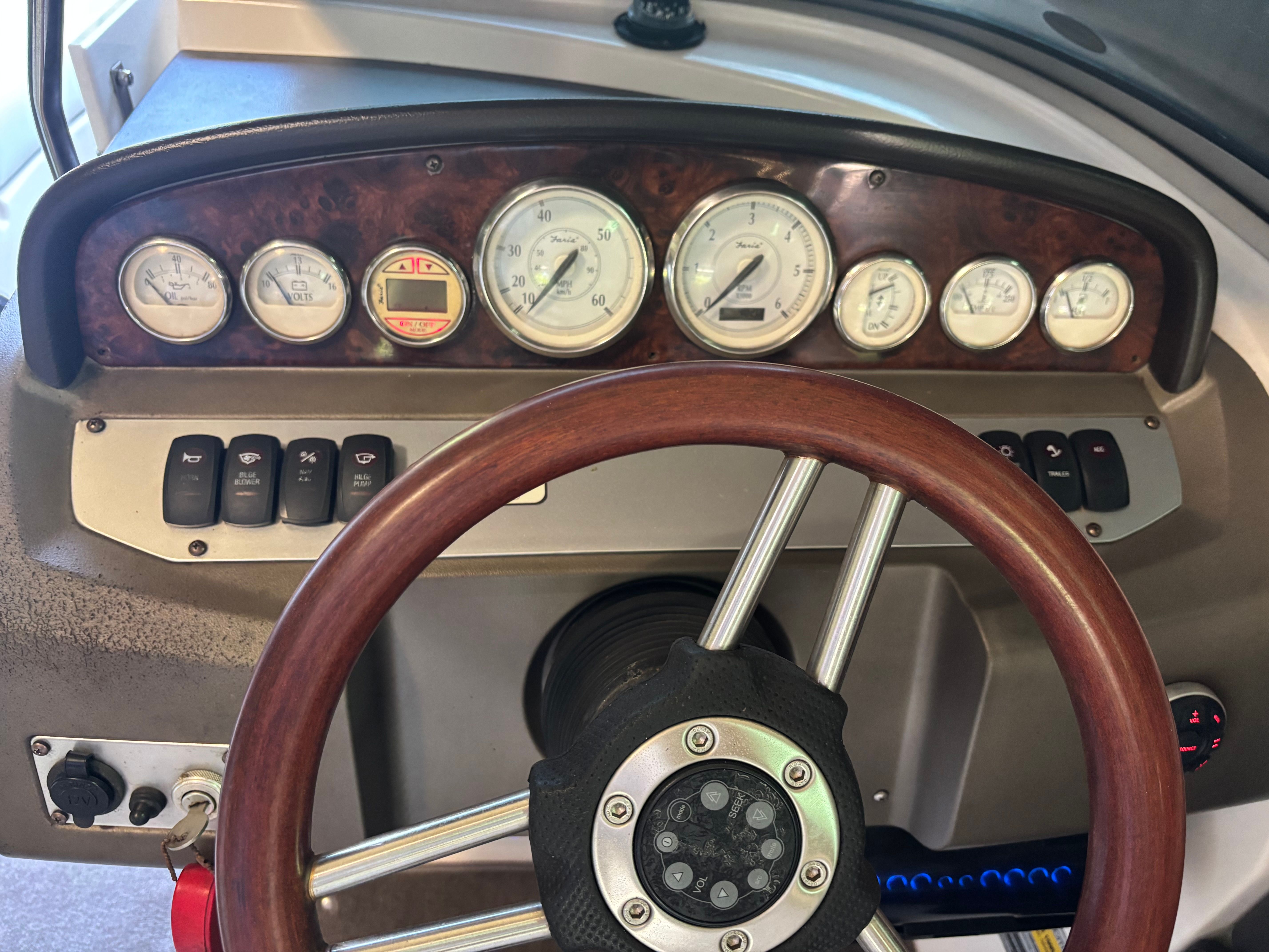 The image shows the dashboard of a 2006 Regal 2200 Bowrider with wood accents and gauges.