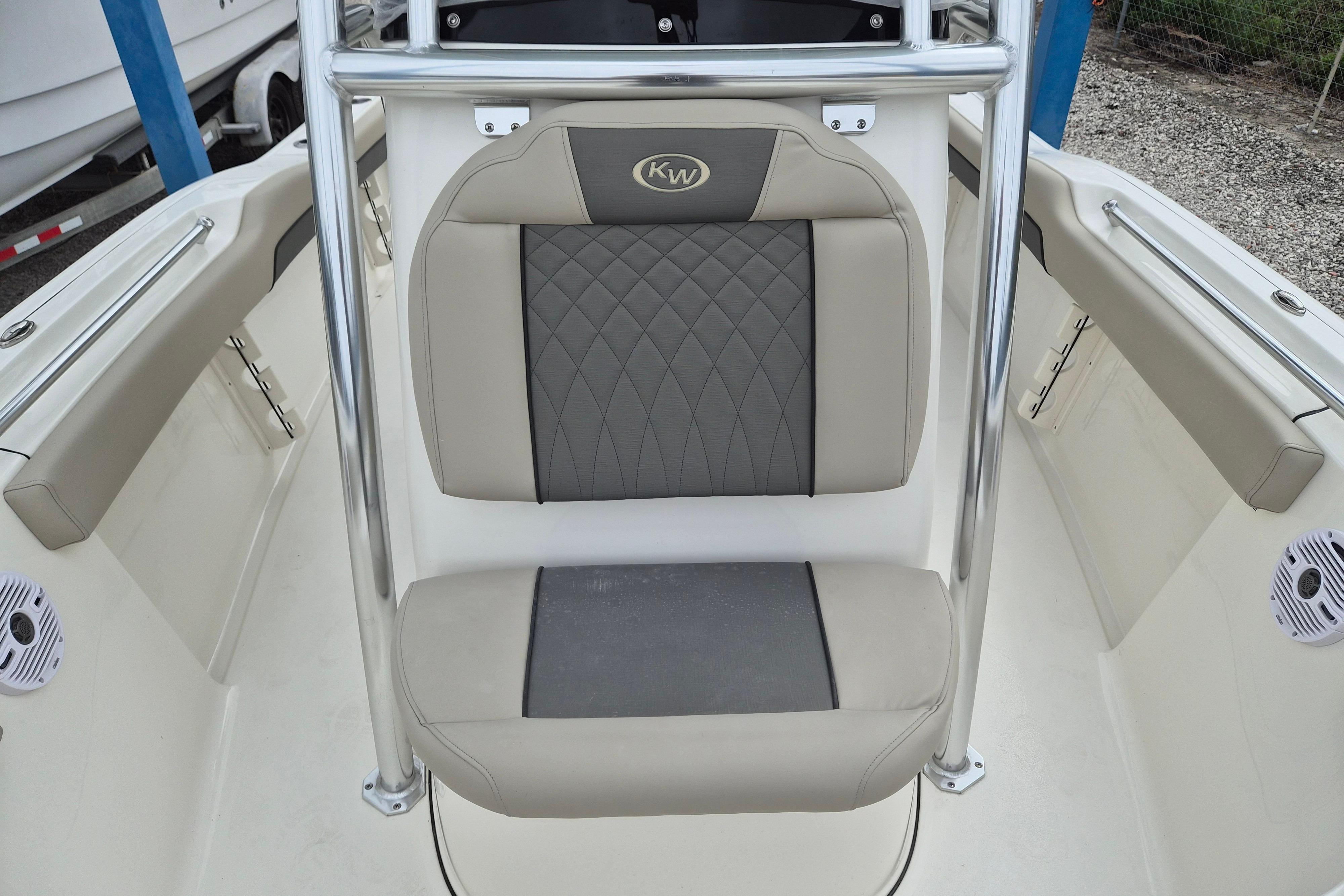 2026 Key West 219 FS boat interior with cushioned seating and stainless steel railings.